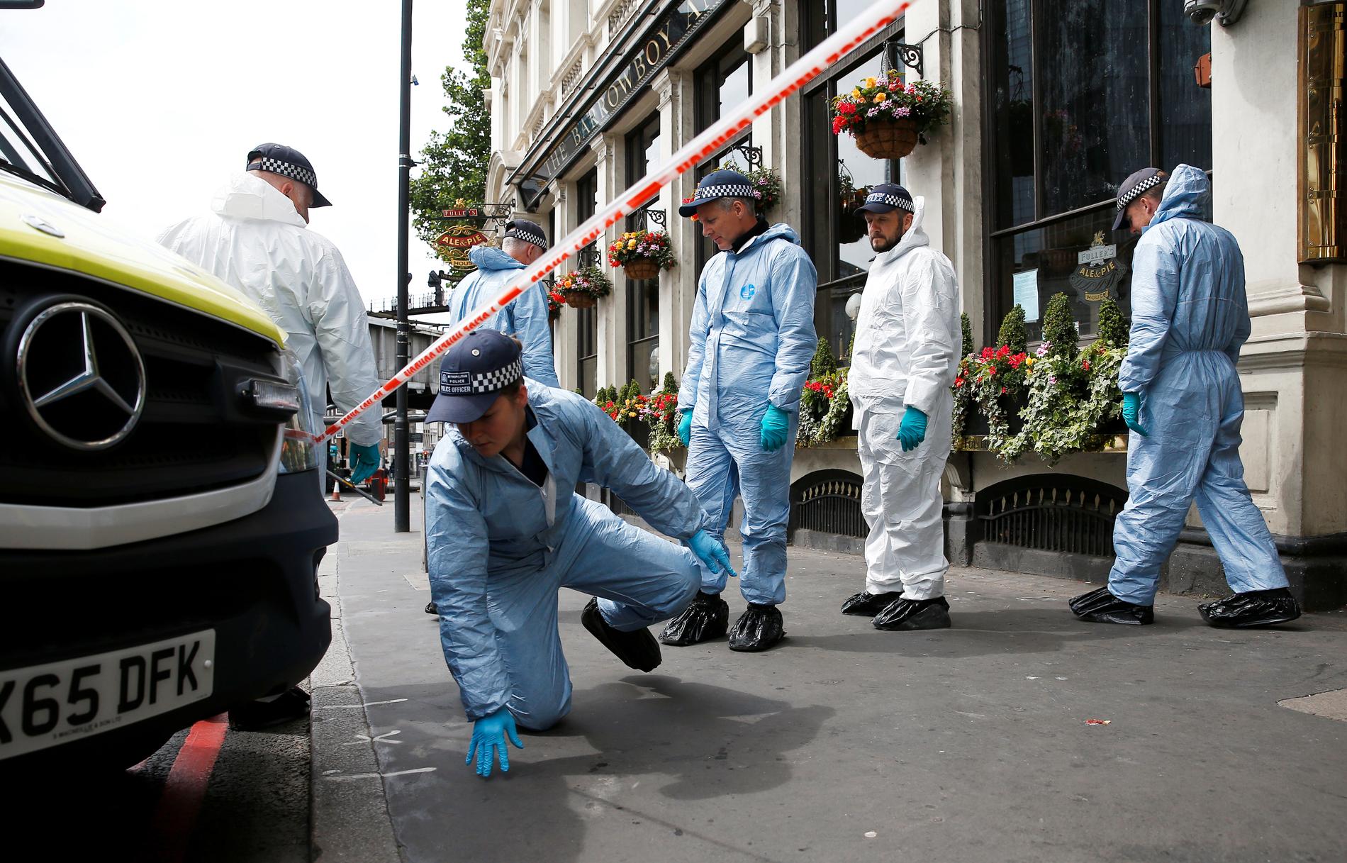 Polistekniker finkammar området kring London Bridge efter terrorattentatet. 