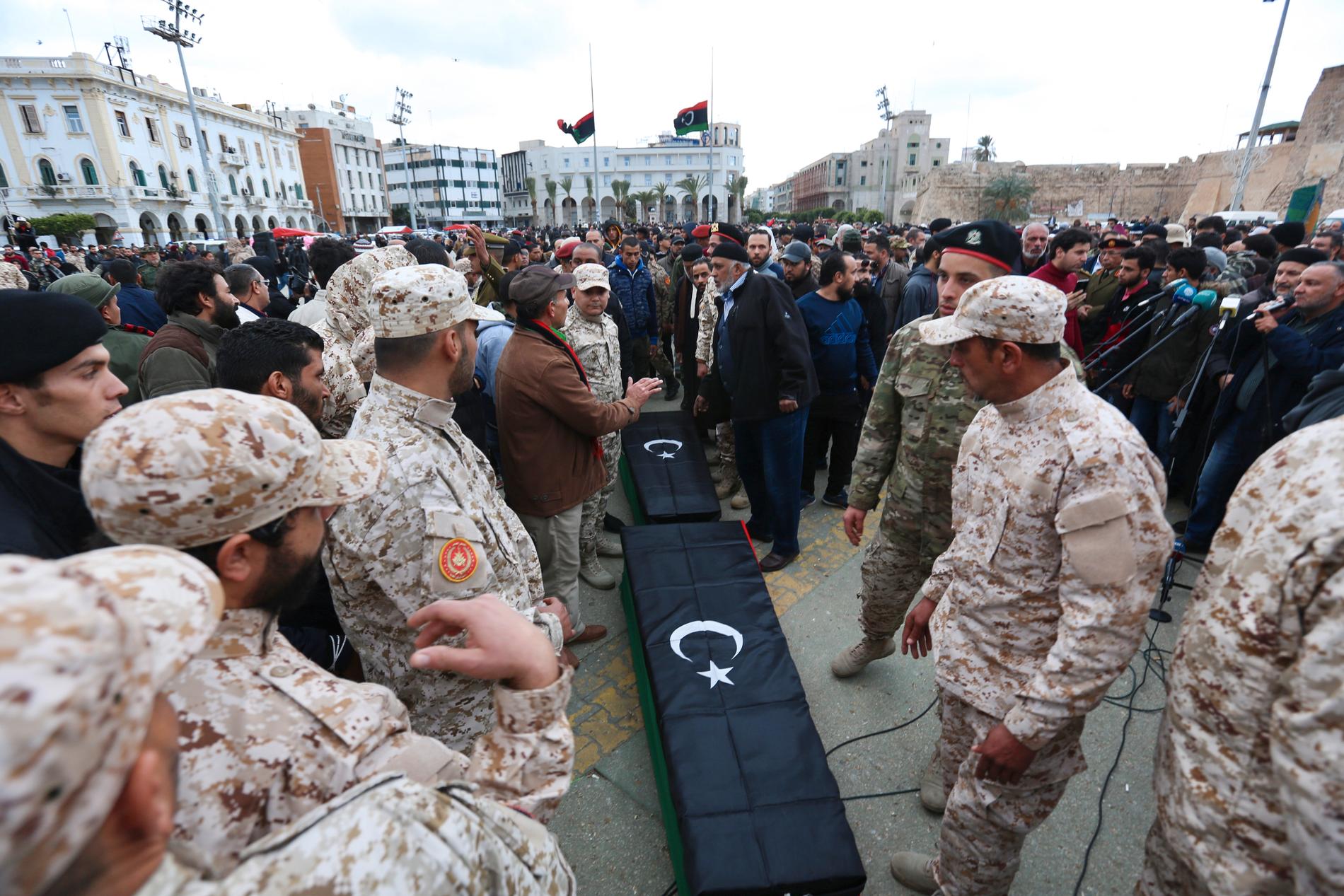 Soldater står vid kistorna i samband med begravningen av några av de kadetter som dödades i en attack i Tripoli tidigare i år. Arkivbild.