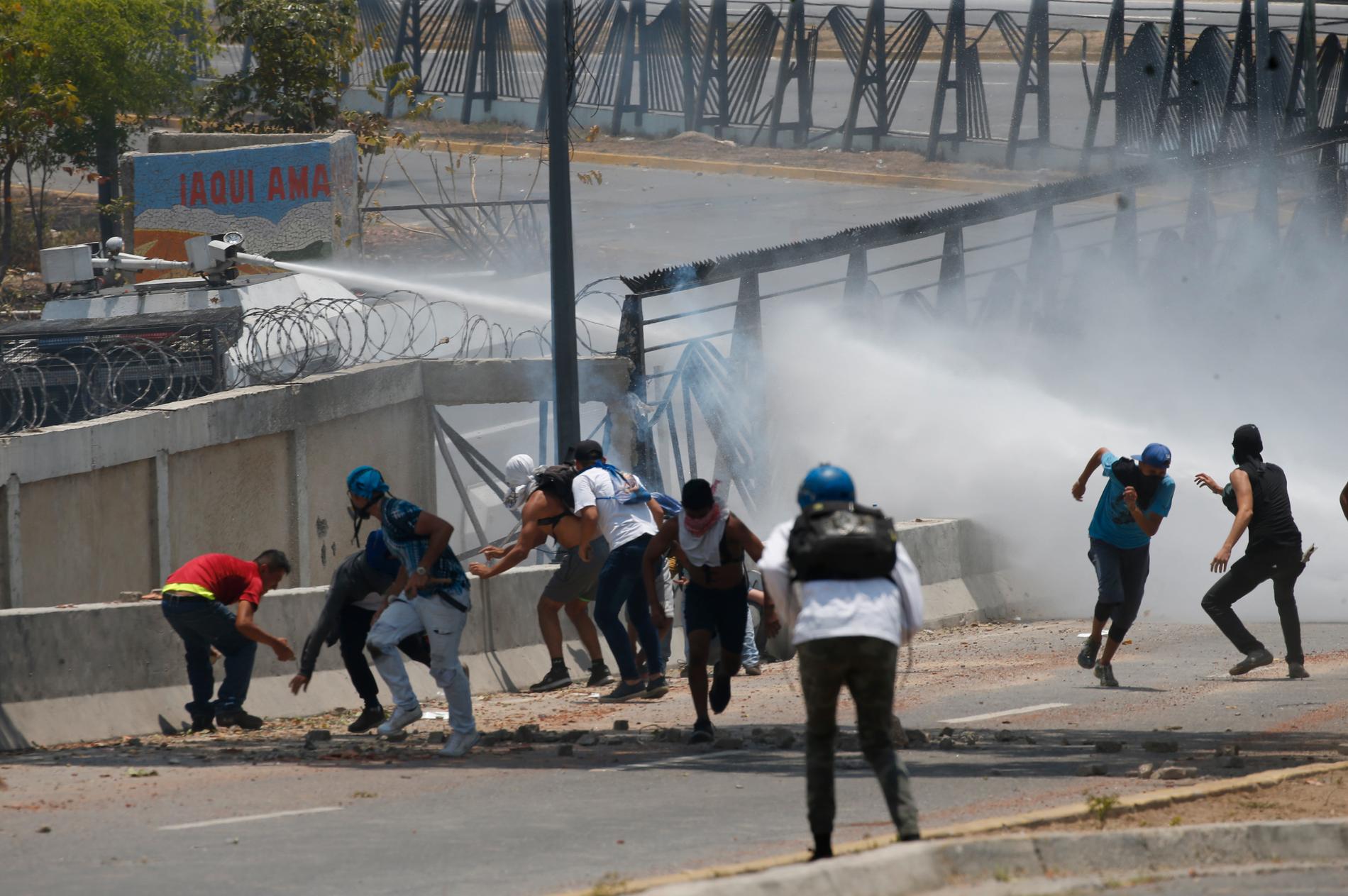 Demonstranter i kamp mot säkerhetsstyrkor i Venezuela under onsdagen.