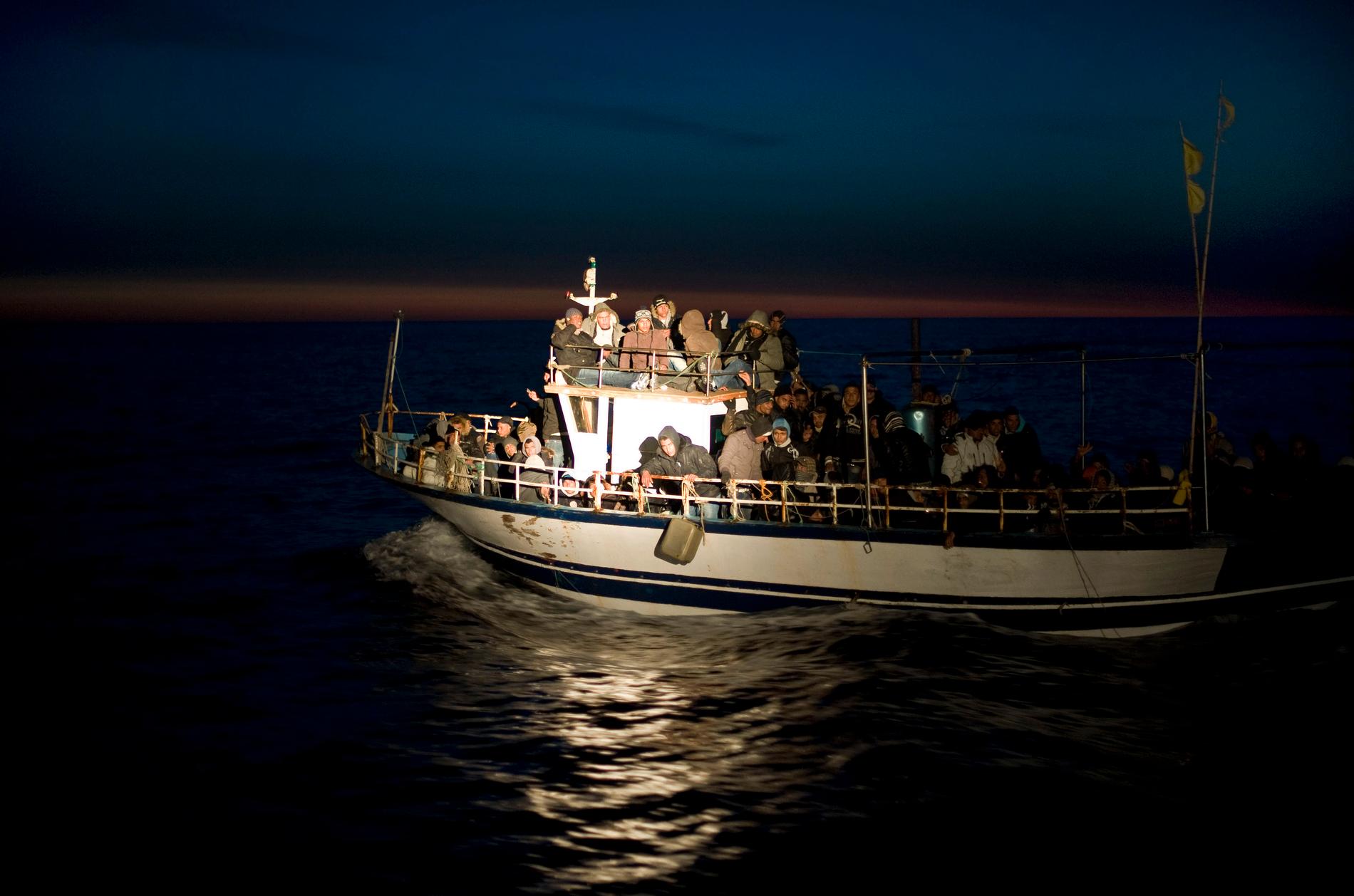 En båt överfull med flyktingar från Nordafrika upptäcks av italiensk kustbevakning utanför ön Lampedusa.