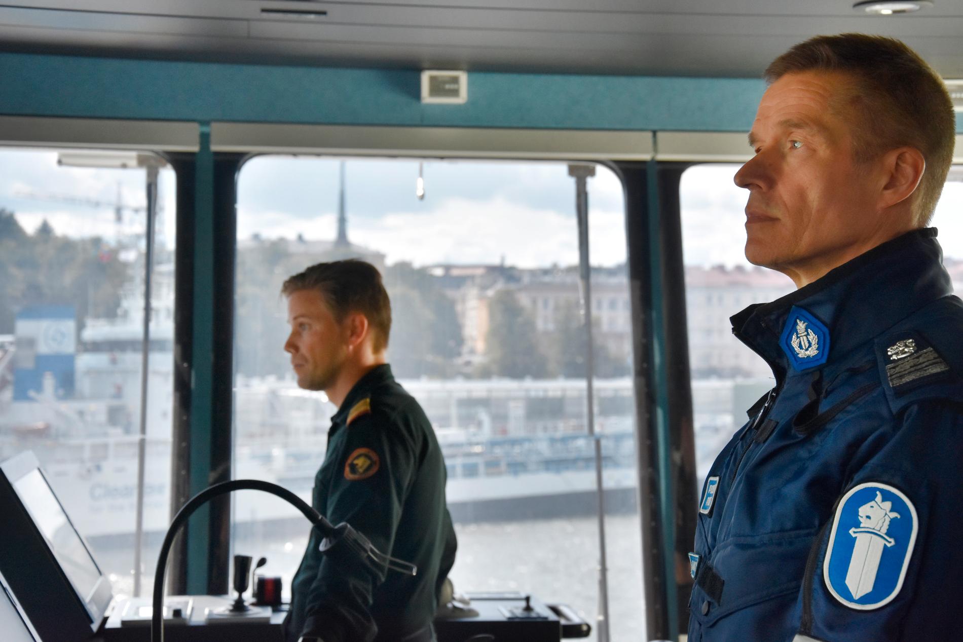 Polis och gränsbevakare spanar från bryggan på finländska kustbevakarfartyget Turva.