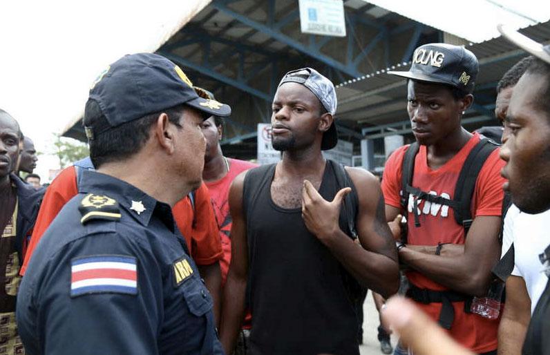 Kubanska migranter grälar med en gränspolis i staden Paso Canoas i Costa Rica. Migranterna vill till USA.