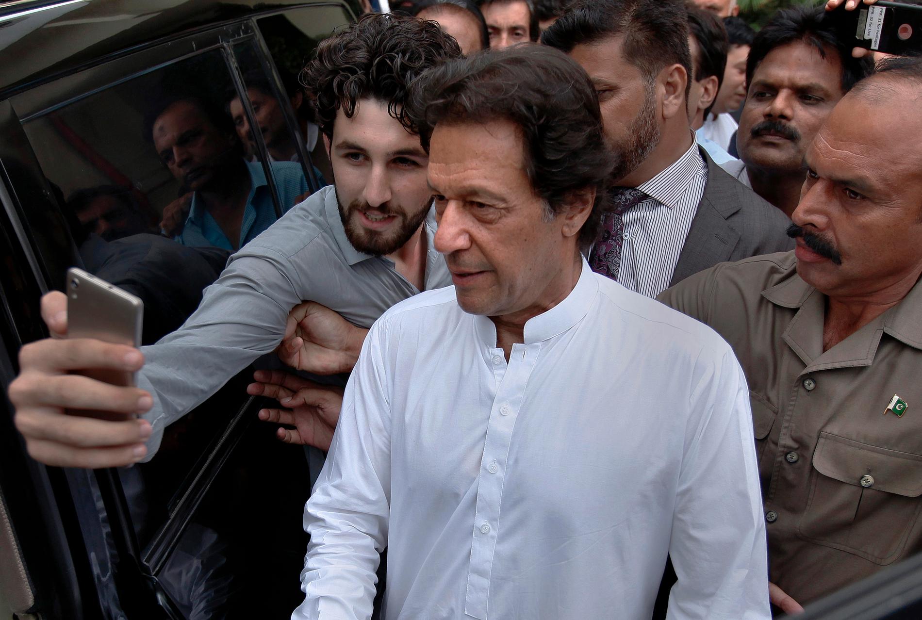 En man tar en selfie med Imran Khan när denne lämnar ett möte med sitt parti härom veckan. Arkivbild.