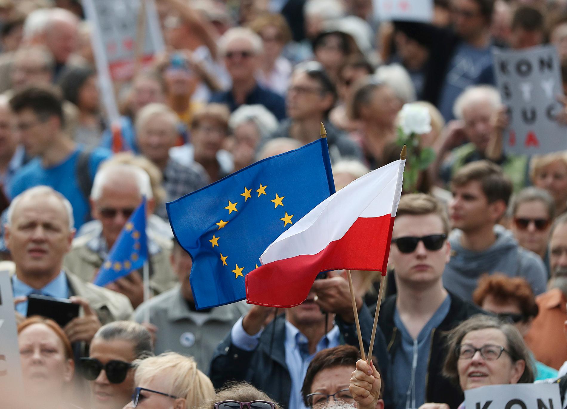 Polens flagga och EU-flaggan vajar tillsammans vid en demonstration i Warszawa. Arkivfoto.