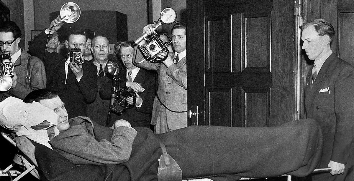 Den åtalade domaren Folke Lundqvist bärs in i rätten på bår 1953. Huvudpersonen i ”Lundqvistaffären”, hade halkat i trädgården och skadat benet. Lundqvist hölls om ryggen av lagens män men fälldes till slut för bedrägeri.