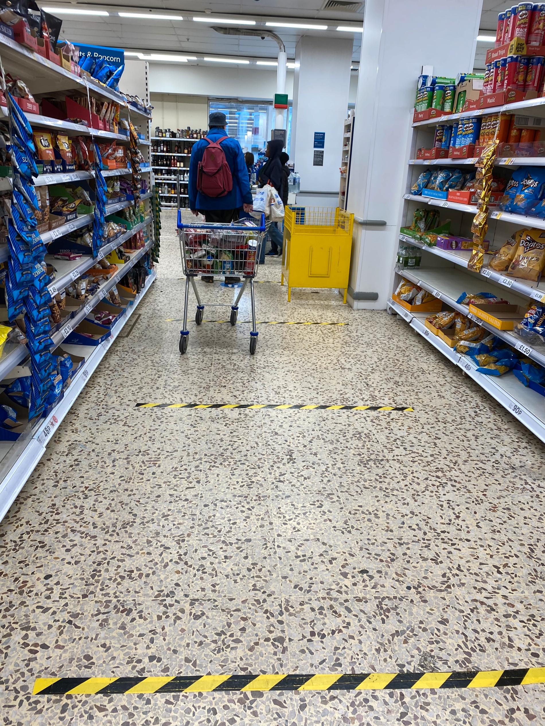 Markings on the floor in  supermarkets helps customers keep their distance to others in London. 