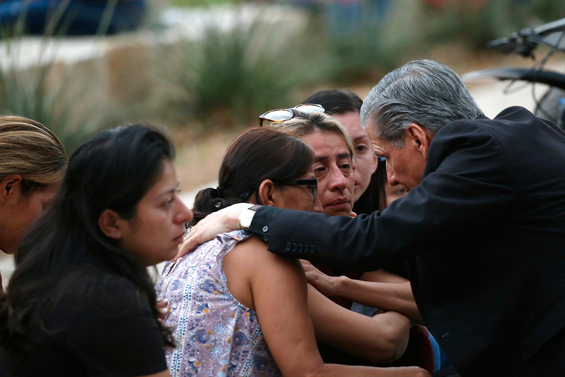 San Antonios ärkebiskop Gustavo Garcia-Siller tröstar familjer.