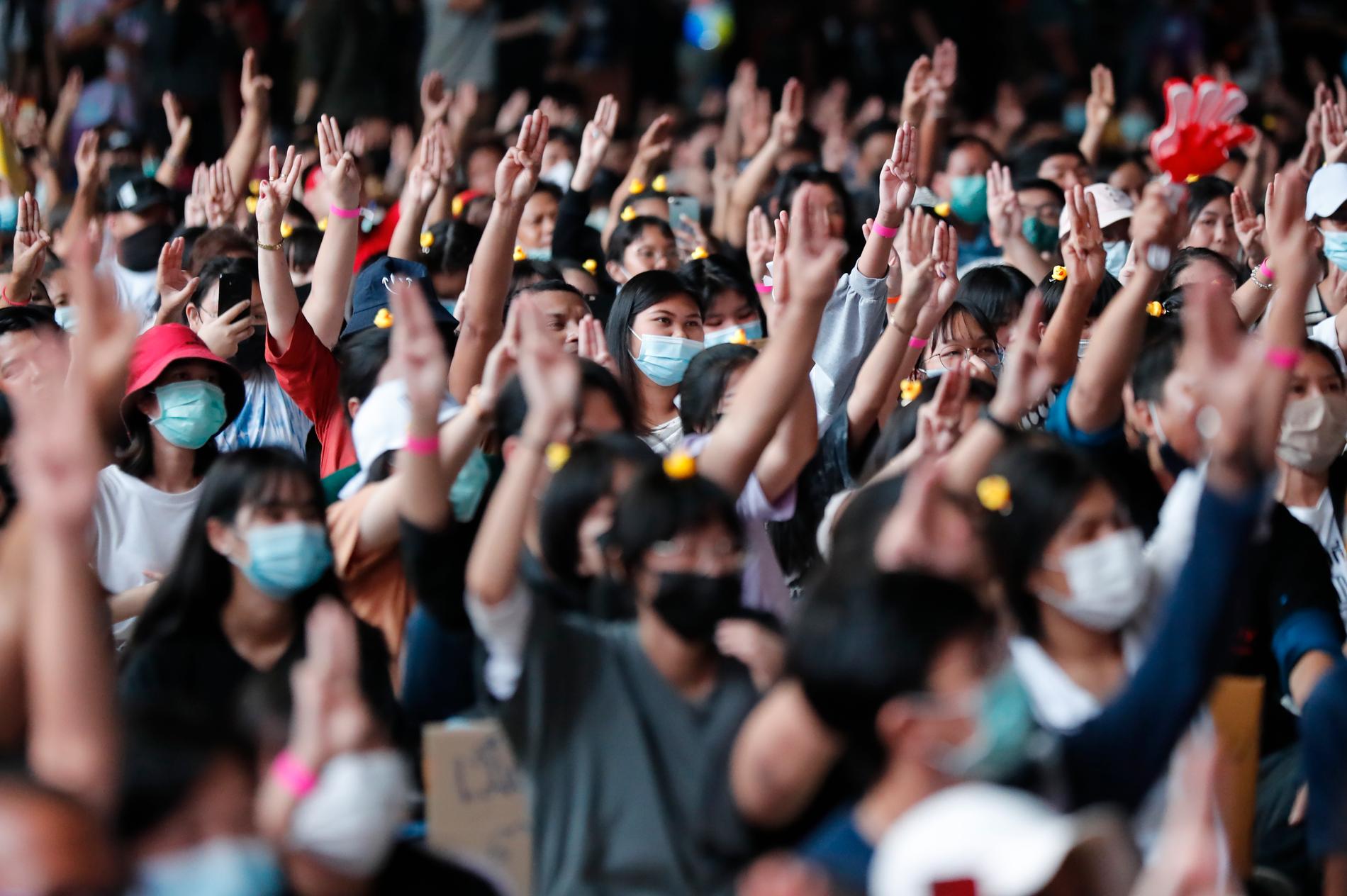 Gymnasieelever gör den regeringskritiska trefingershälsningen under lördagens demonstration i Bangkok, Thailand.