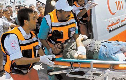 KRIGETS OFFER En skadad palestinier tas om hand efter Israels attack mot flyktinglägret Mughazi.