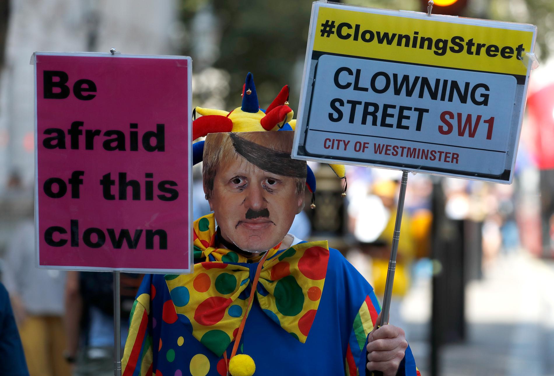 En clownklädd man med en Boris Jonssonmask protesterar utanför den brittiska premiärministerns kansli på 10 Downing Street i London, dagen efter att Jonsson beslutat att förlänga parlamentet stängningstid.