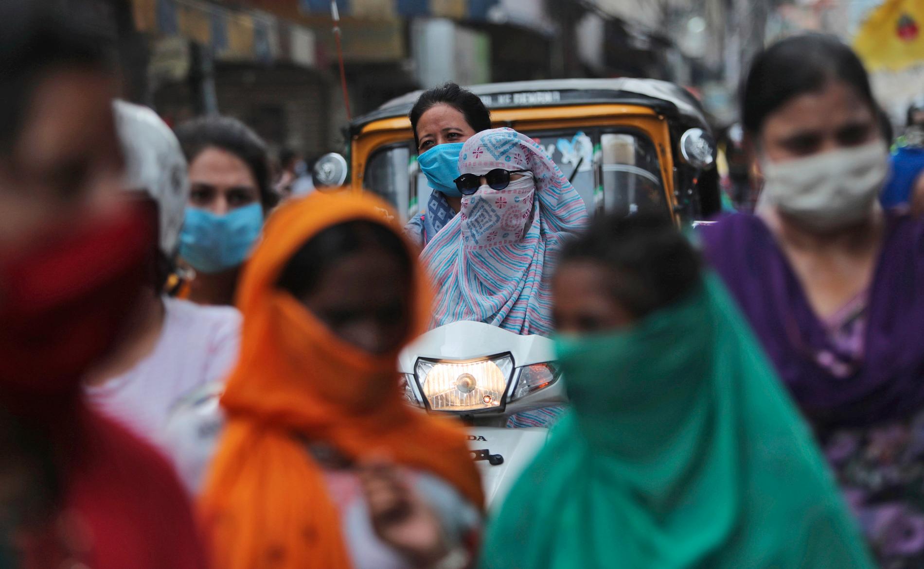 Människor med munskydd vid en marknad i indiska Jammu. Indien har blivit ett av de värst drabbade länderna i världen.