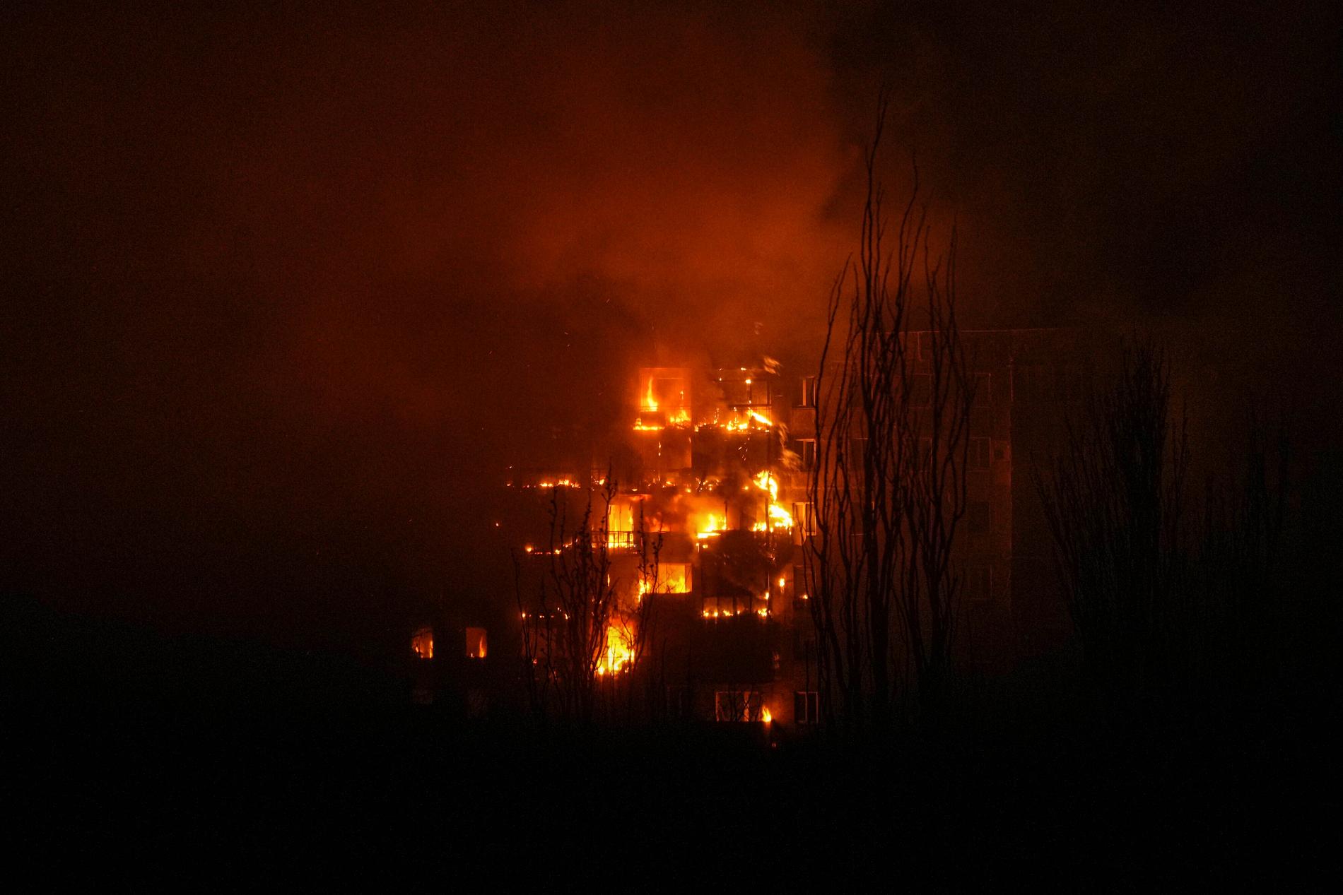 En byggnad i Mariupol brinner efter en rysk bombattack.