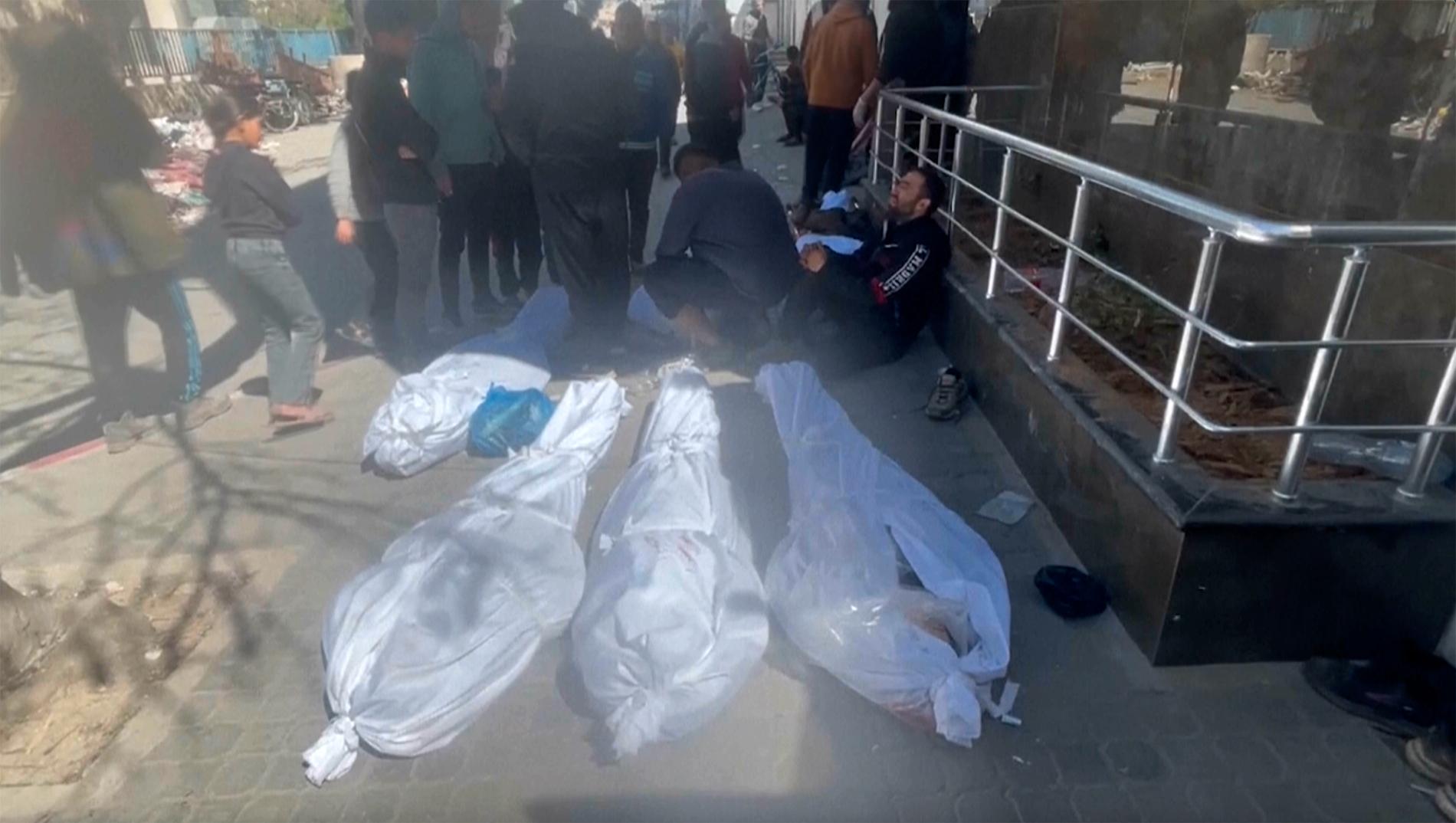  Kroppar ligger insvepta i vita höljen på marken utanför Shifa-sjukhuset i Gaza City. Bilden är en skärmdump från en video. 