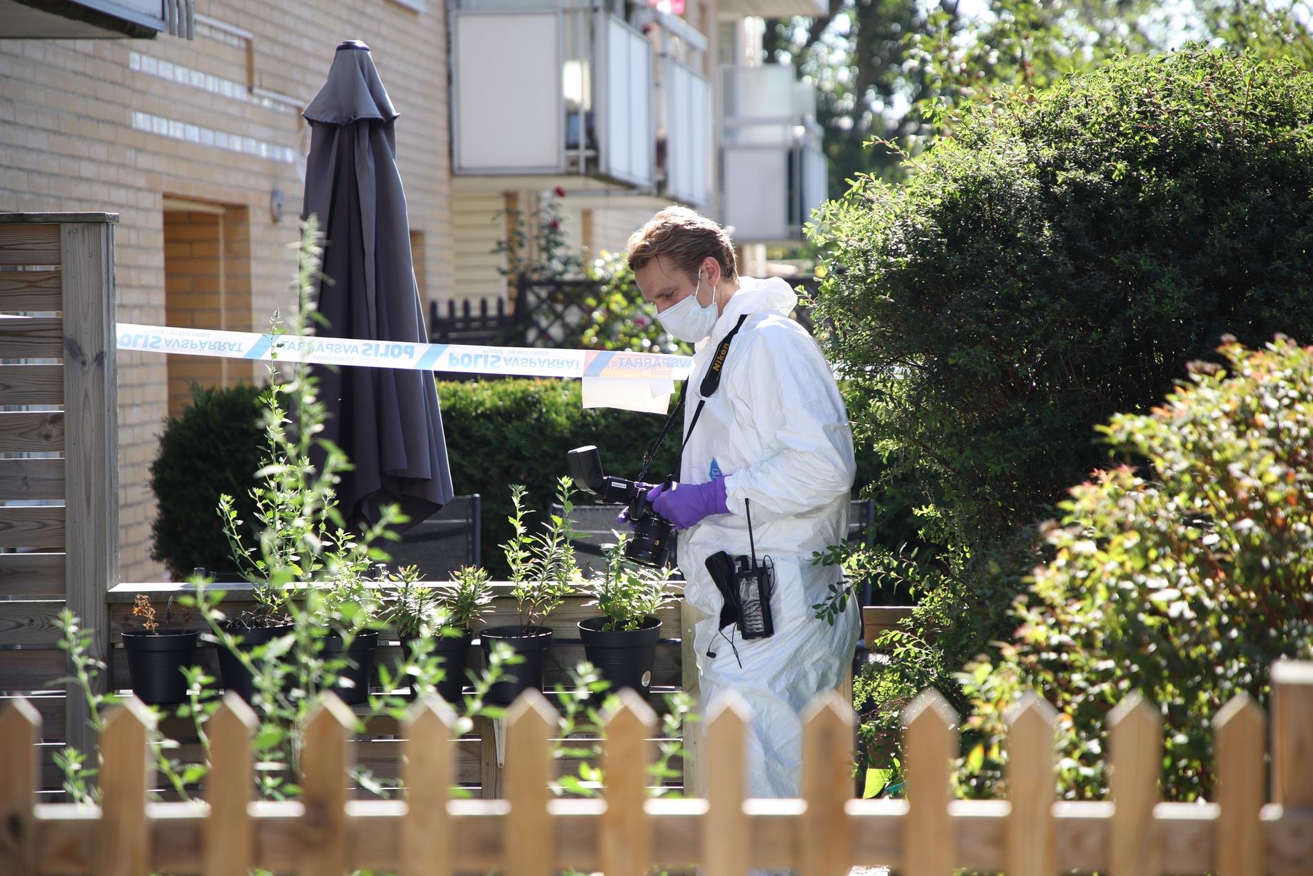 Rättstekniker utanför den byggnad där tre personer – en mamma och två barn – hittades döda i Västra Frölunda.