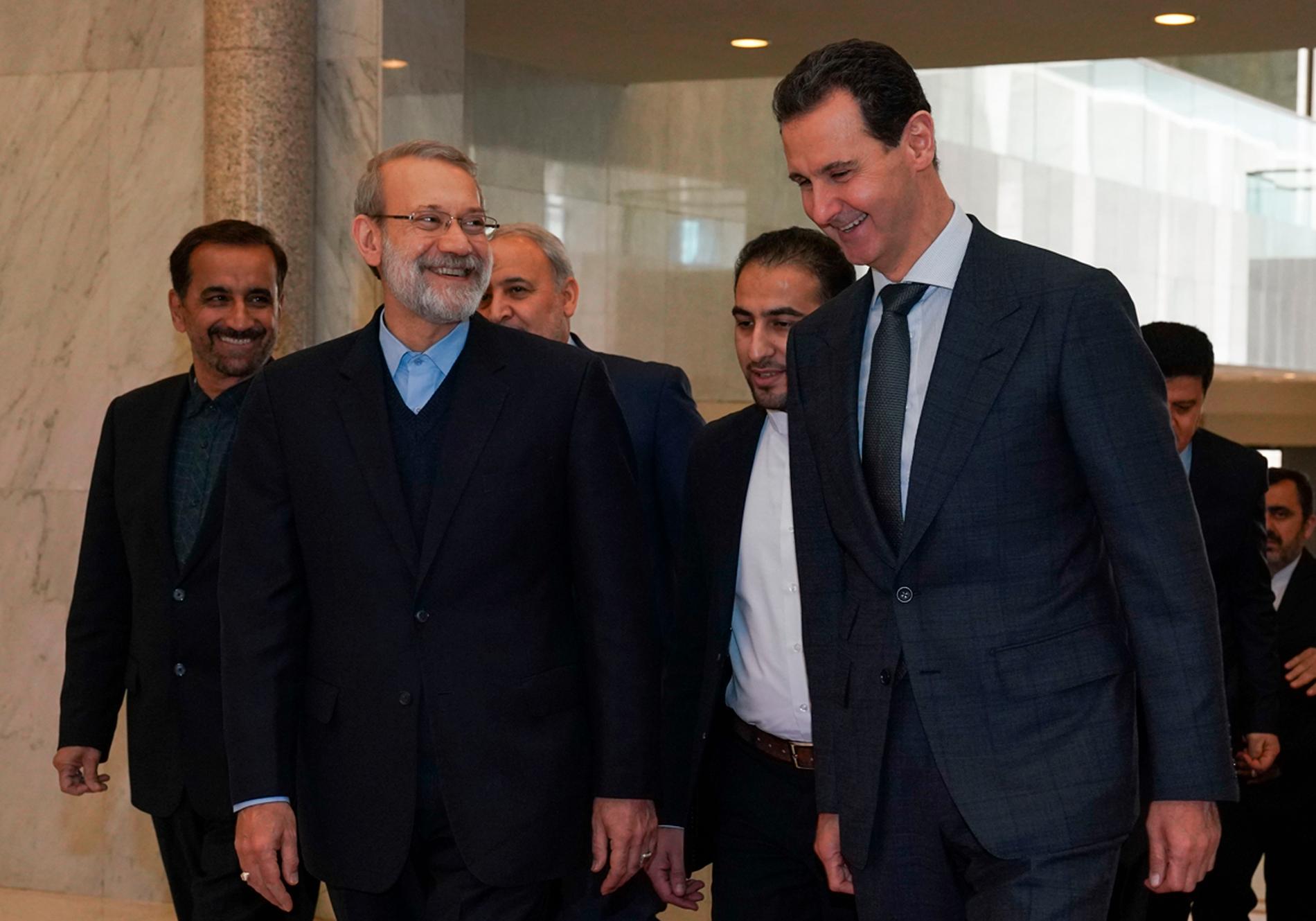 Dt iranska parlamentets talman Ali Larijani (till vänster) under ett besök i Syriens huvudstad Damaskus på söndagen där han träffade president Bashar al-Assad.