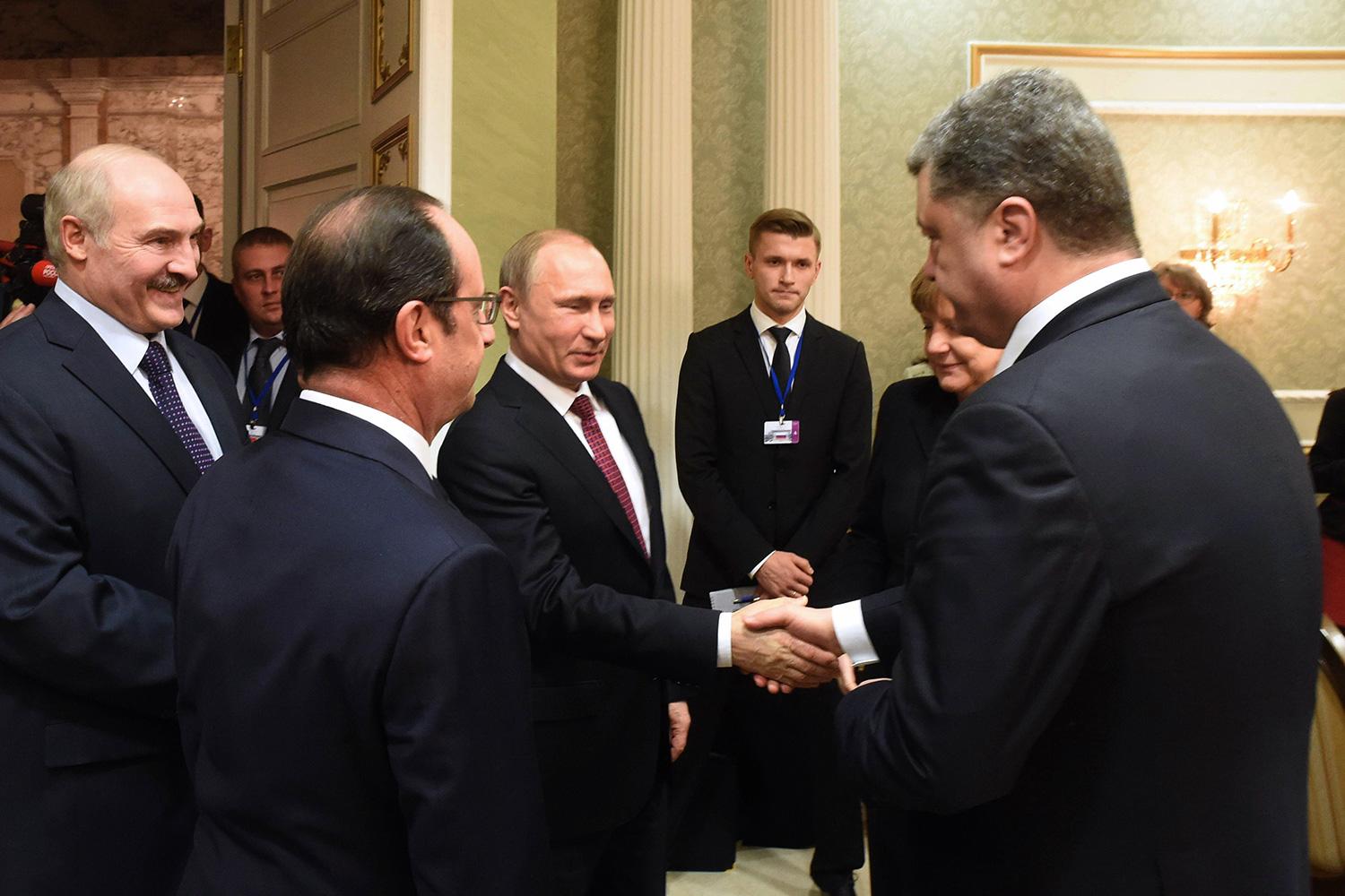 Putin skakar hand med Ukrainas president Petro Porosjenko.
