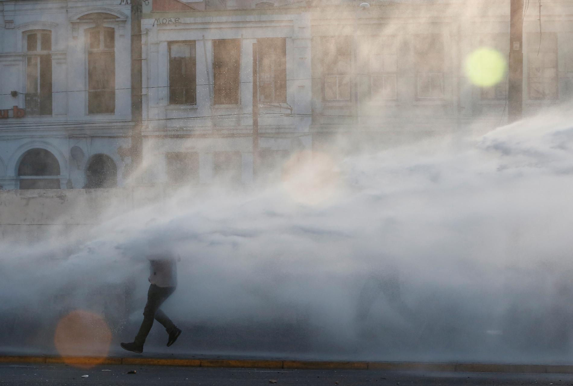Polisen använder vattenkanoner mot demonstranter i Valparaíso.