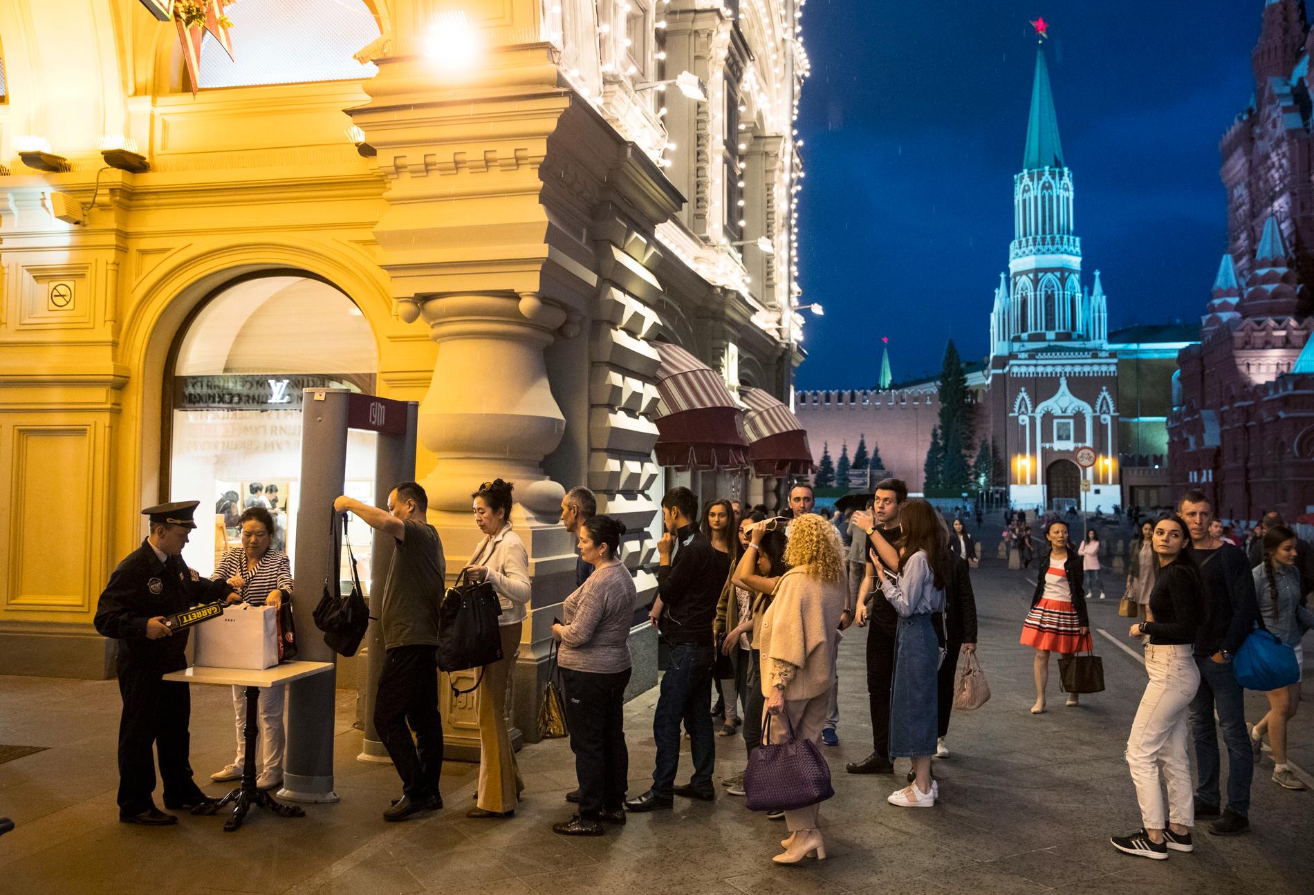 Människor kontrolleras innan de får gå in på varuhuset Gum vid Röda torget i Moskva. En våg av falska bombhot har plågat Moskva och andra ryska städer.