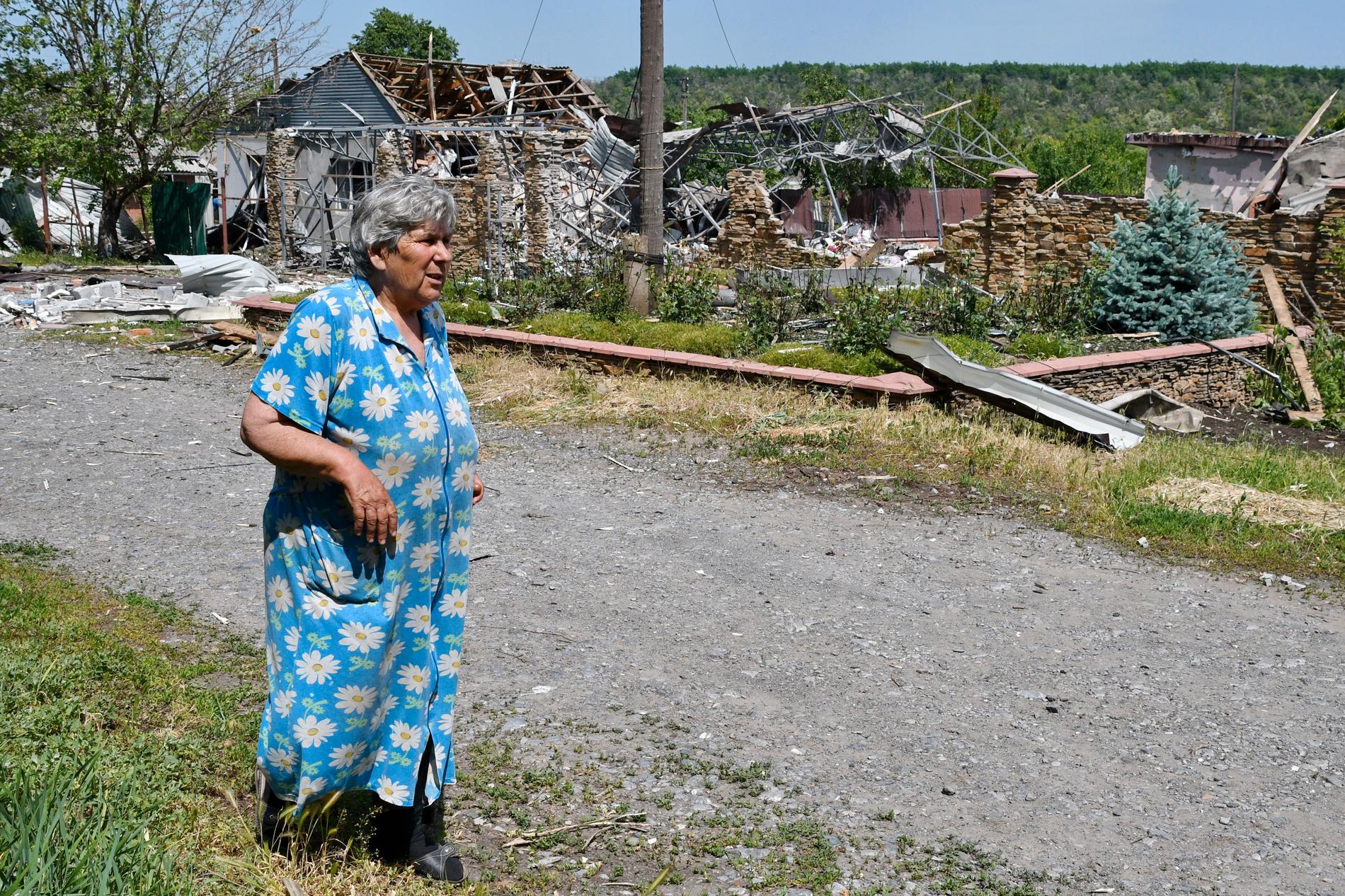 En kvinna går förbi byggnader som anfallits i Slovjansk, nära Kramatorsk i östra Ukraina, på onsdagen.