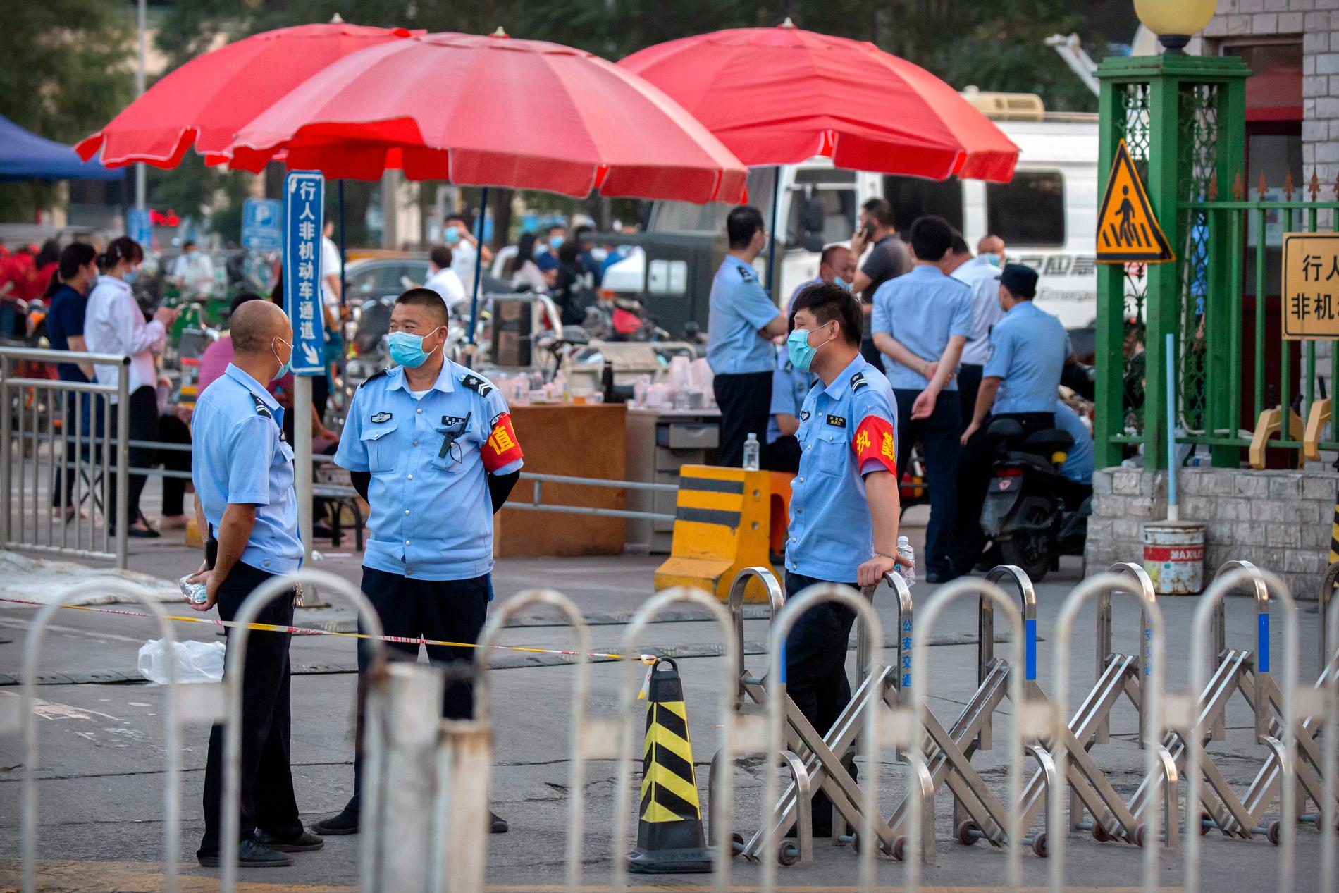 Polis vid ingången till köttmarknaden i Peking.