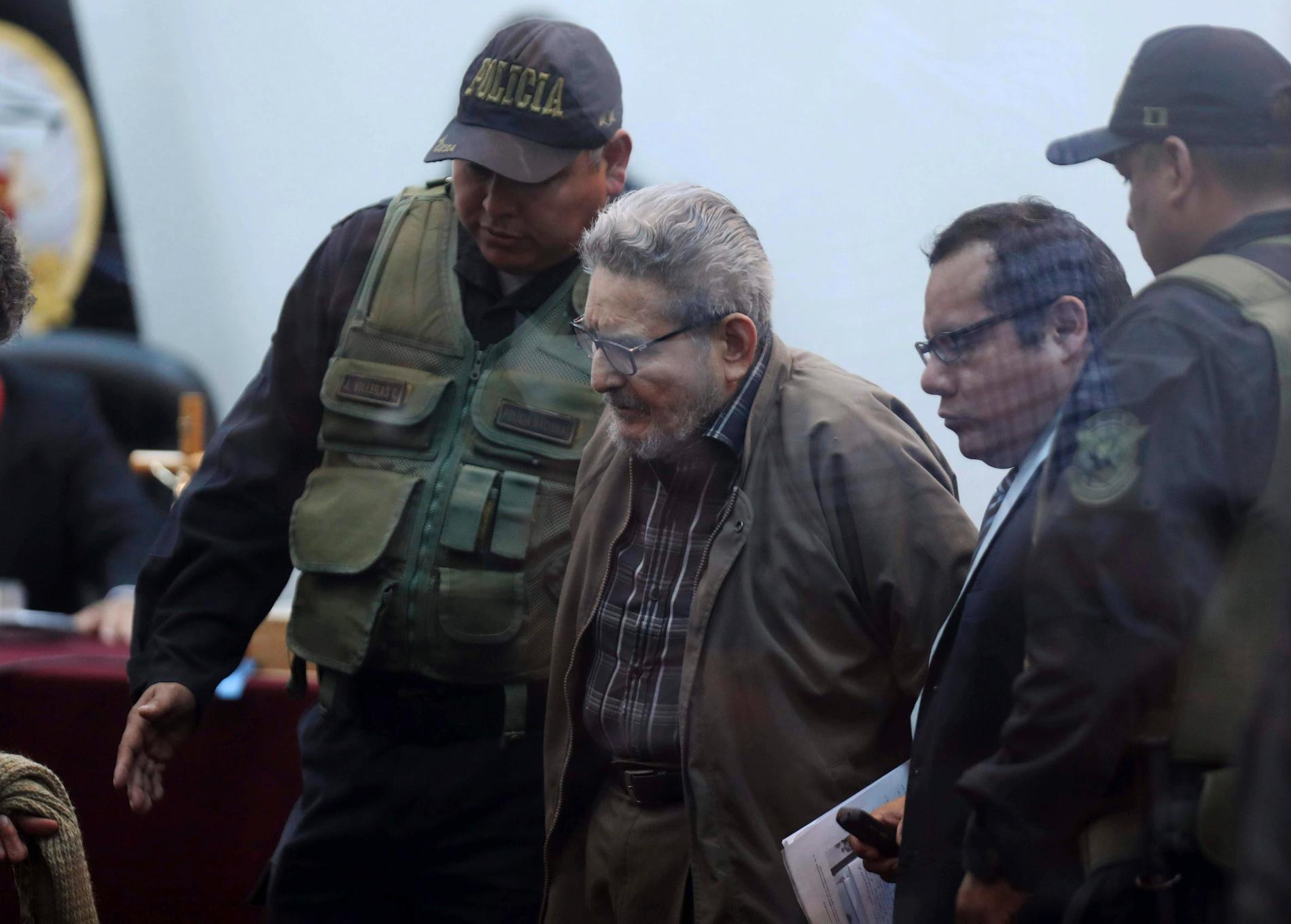 Abimael Guzmán, grundare av maoistgerillan Sendero Luminoso, anländer till rätten vid en militärbas i Callao utanför Perus huvudstad Lima på tisdagen.