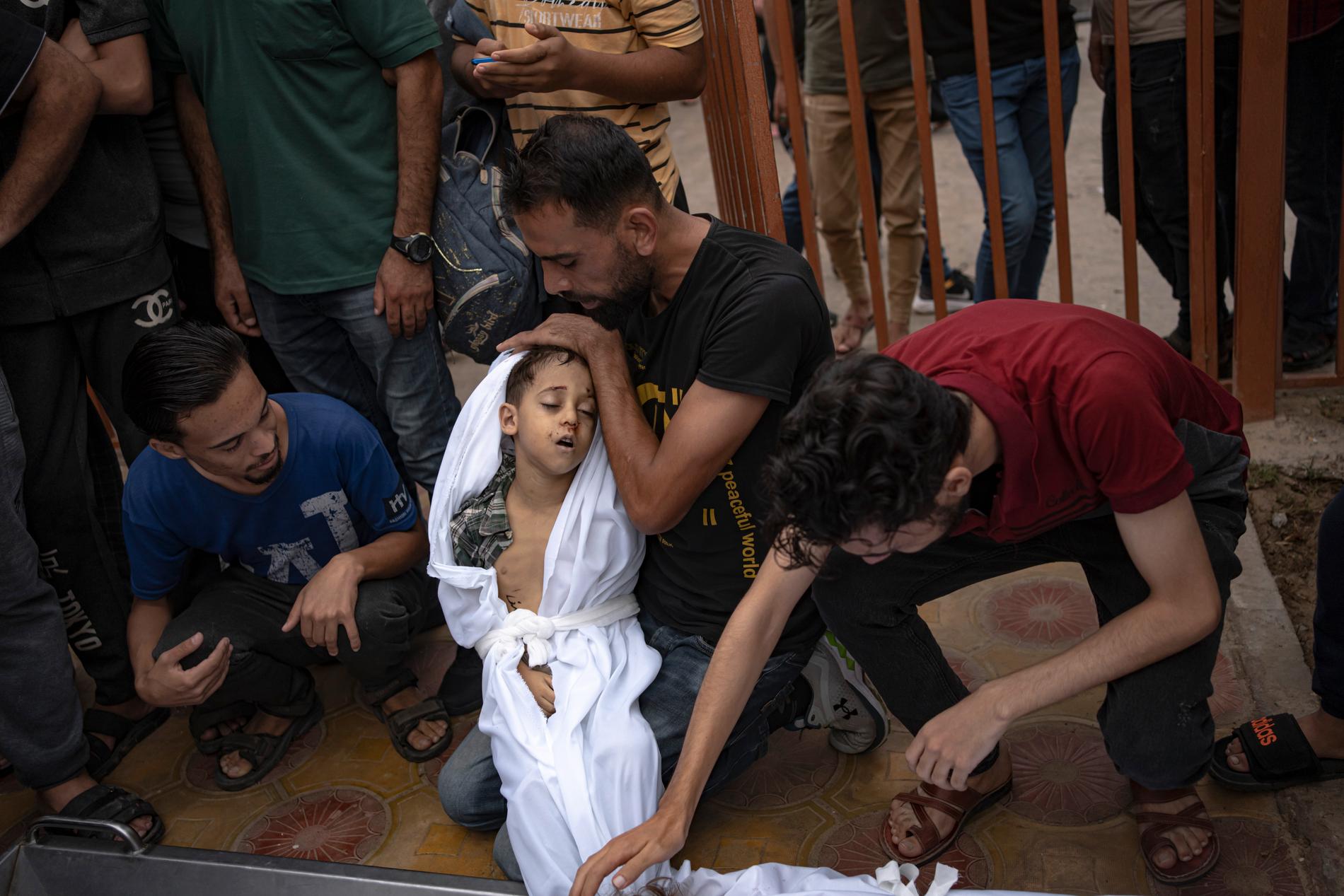 Anhöriga sörjer en dödad pojke i Khan Younis på Gazaremsan efter söndagens bombanfall.