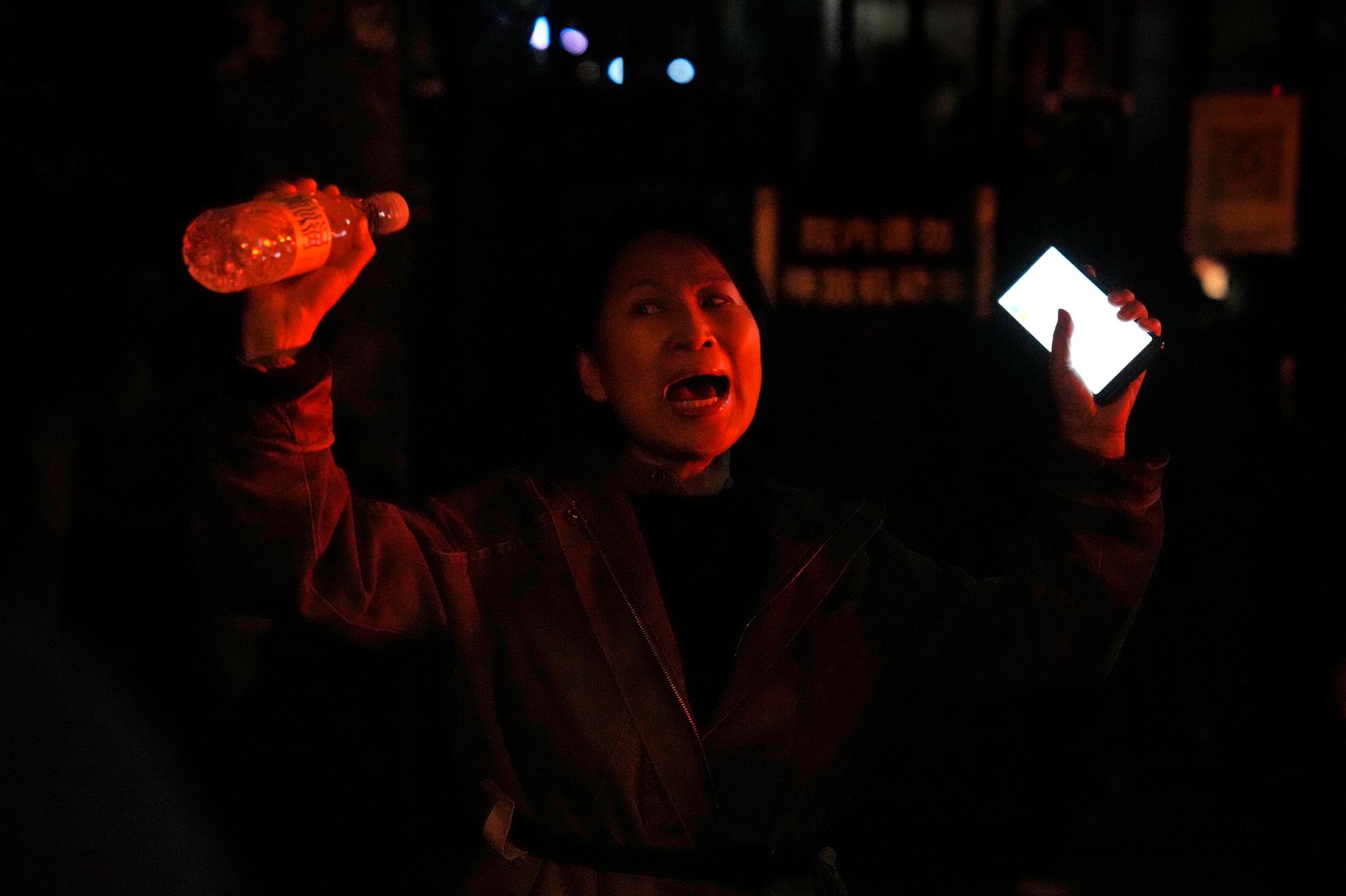 En kvinna protesterar i Peking mot regimens strikta "nollcovid"-politik.