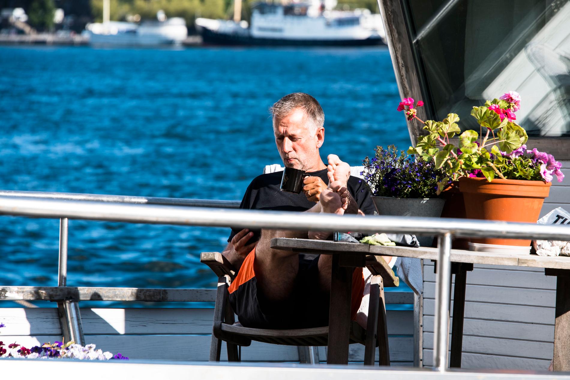 Mikael Gustafsson njuter av en kopp kaffe på sin båt Amigo vid Norr Mälarstrand. 
