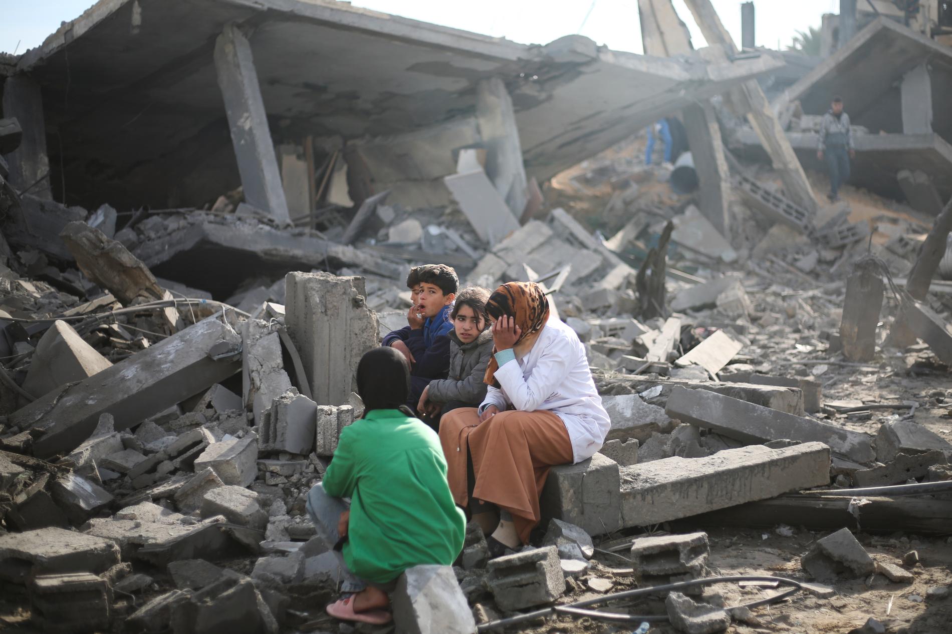 Palestinier i ruinerna i Rafah efter intensiva israeliska bombningar.