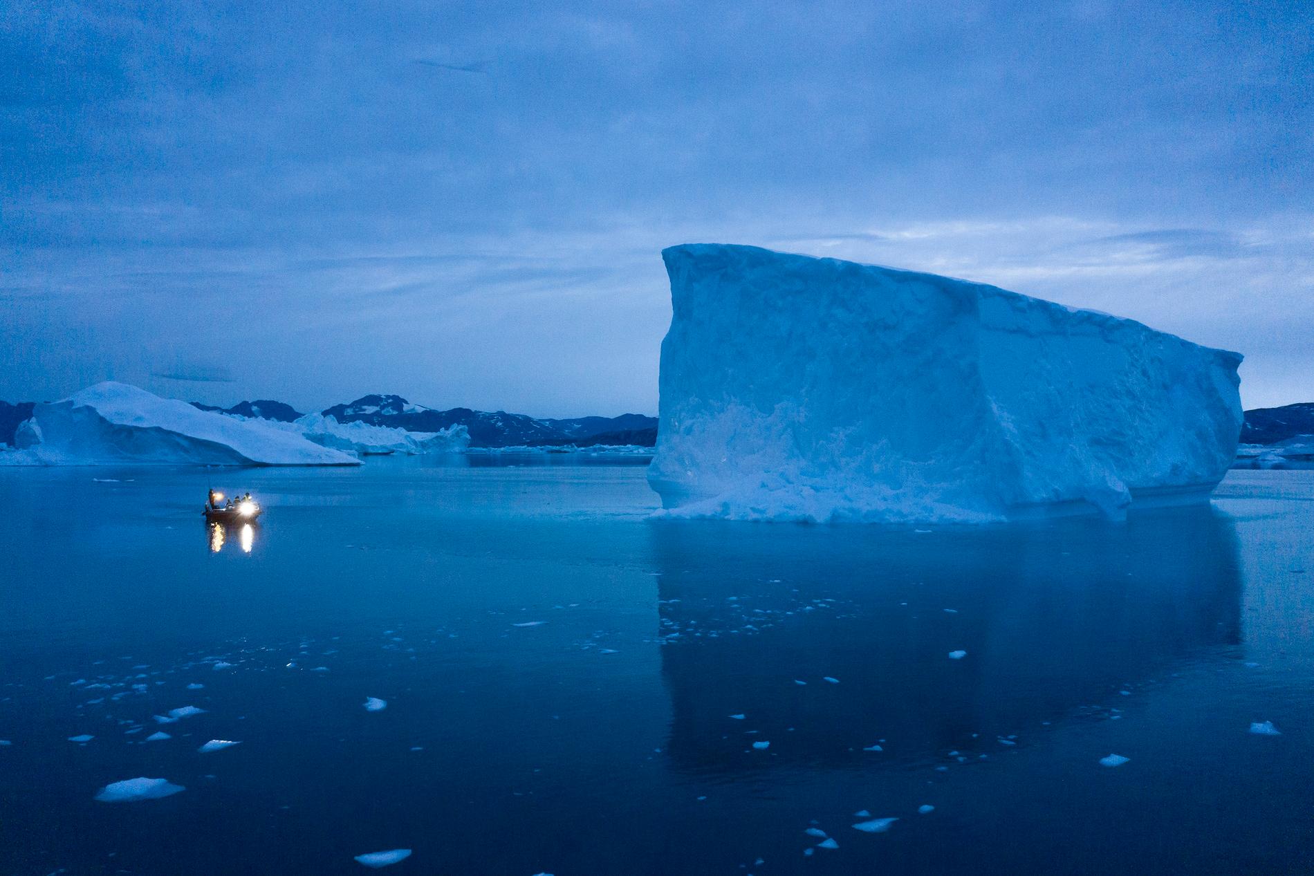 En mindre båt i närheten av ett isberg i östra Grönland. Utbredningen av havsis i Arktis har minskat de senaste decennierna. Arkivbild.