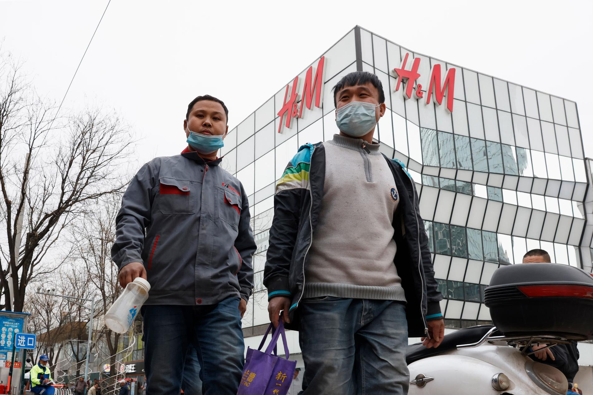 Män framför H&M-butik i Peking.