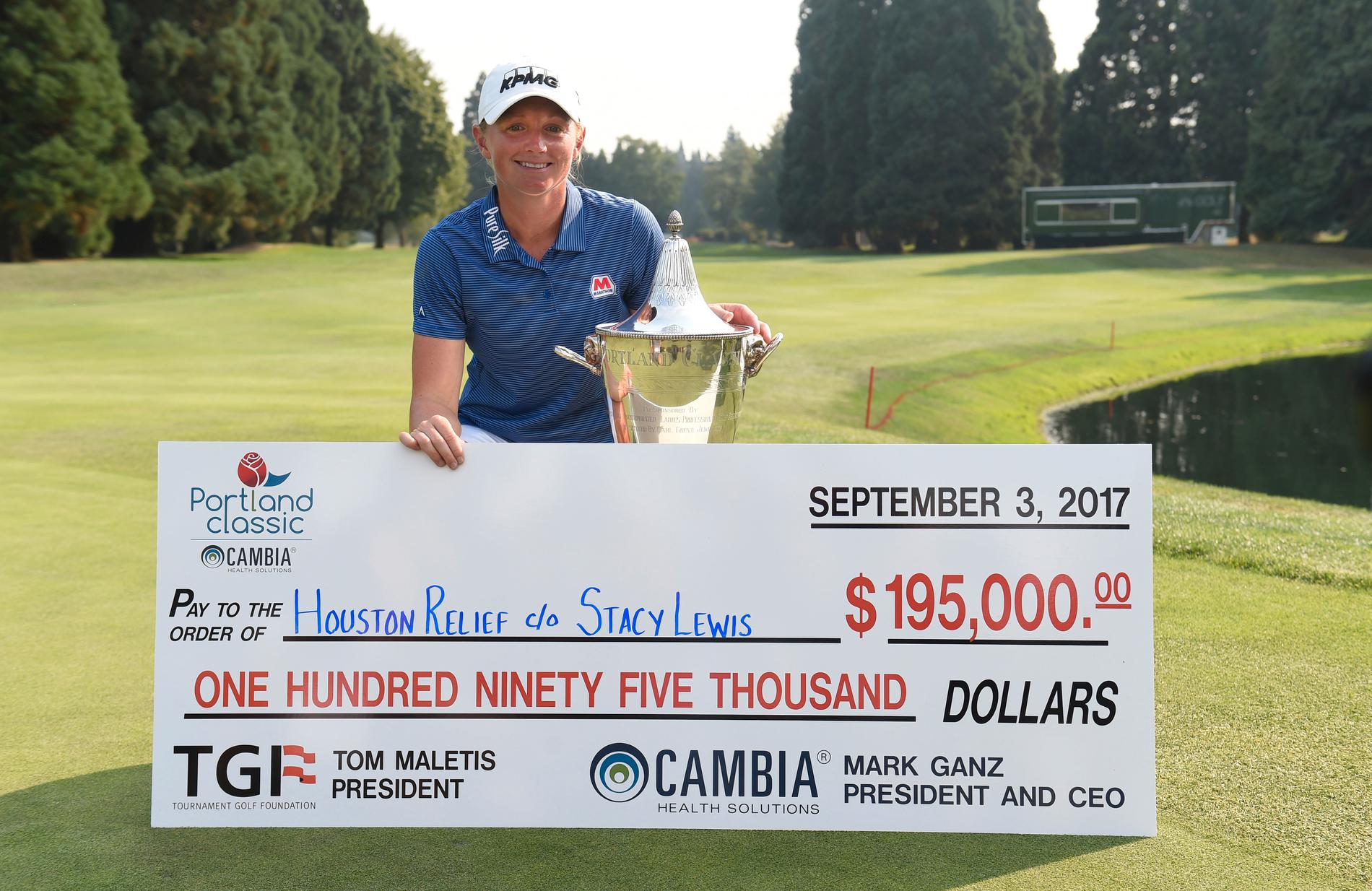 Stacy Lewis tillsammans med segerchecken på 195 000 dollar efter hennes LPGA-segern i Portland. Lewis har lovat att skänka alla prispengar till hjälpinsatserna efter stormen Harvey.