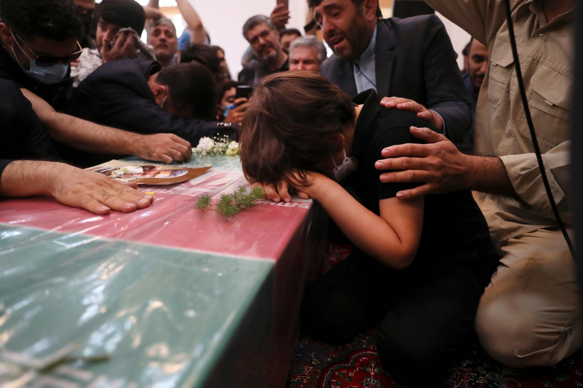 Hassan Sayyad Khodaeis son sörjer vid hans kista under en begravningsceremoni i Teheran i tisdags.