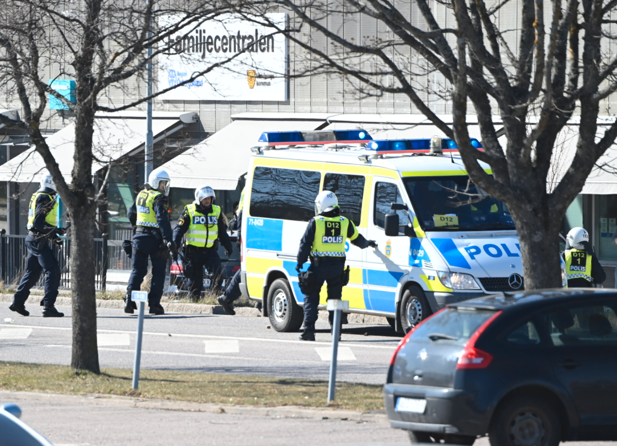 Polis i kravallutrustning i Skäggeby centrum. 