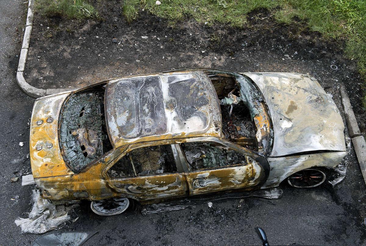 Utbränd bil efter upploppen i Husby
