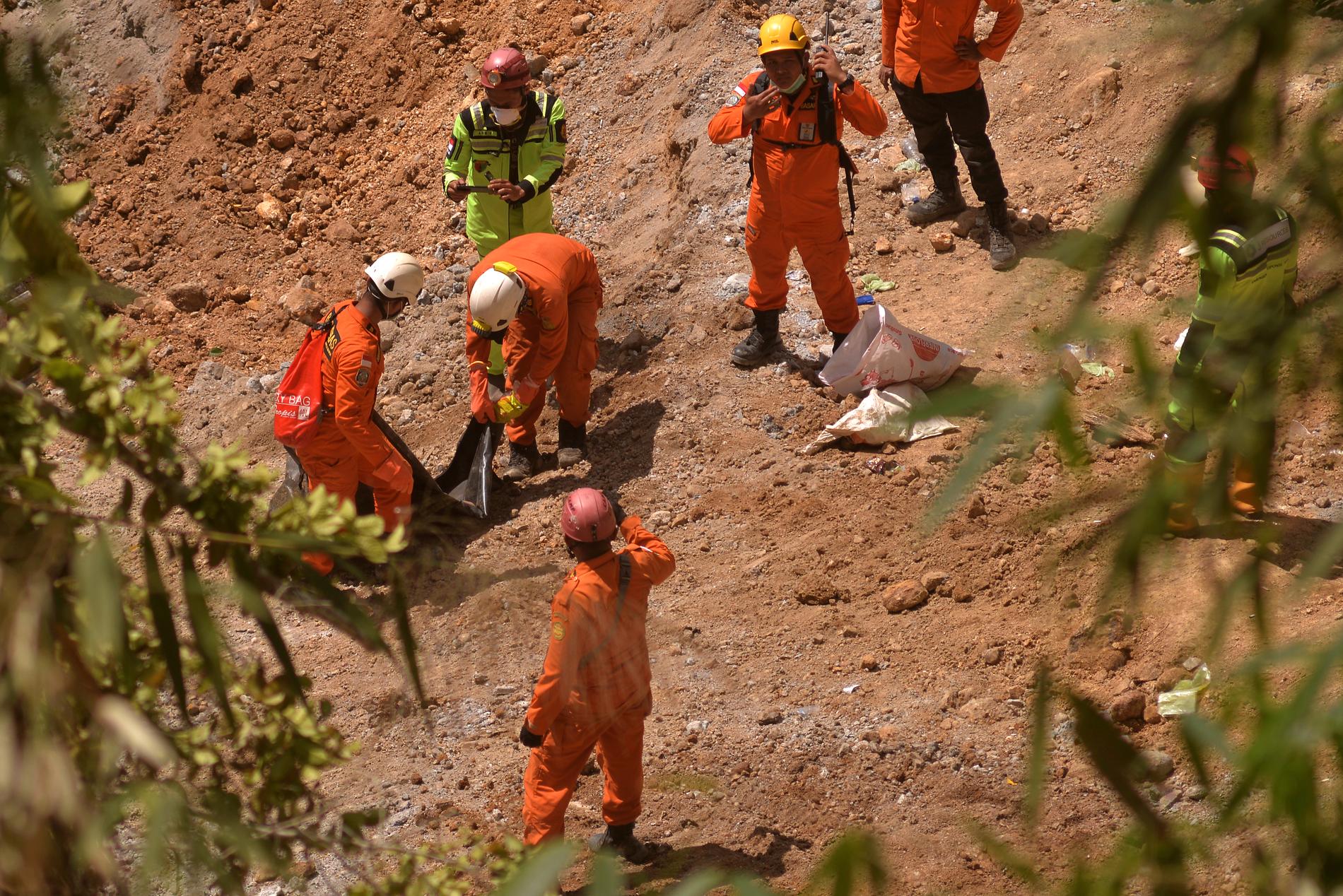 Räddningsarbetare vid den rasade guldgruvan i Indonesien.