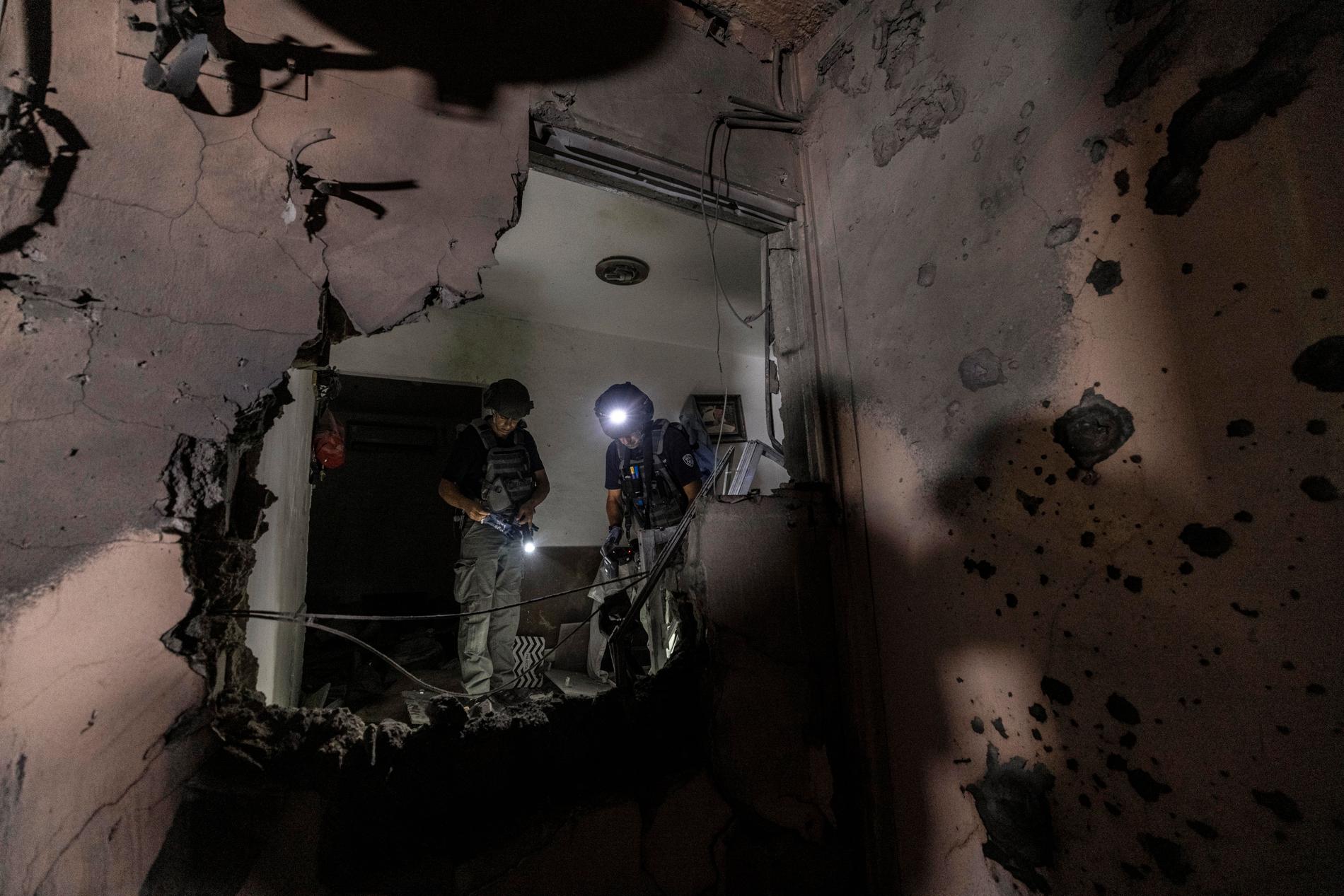 Israeliska bombtekniker undersöker ett hus i Sderot som träffades av en raket från Gaza, 19 maj.