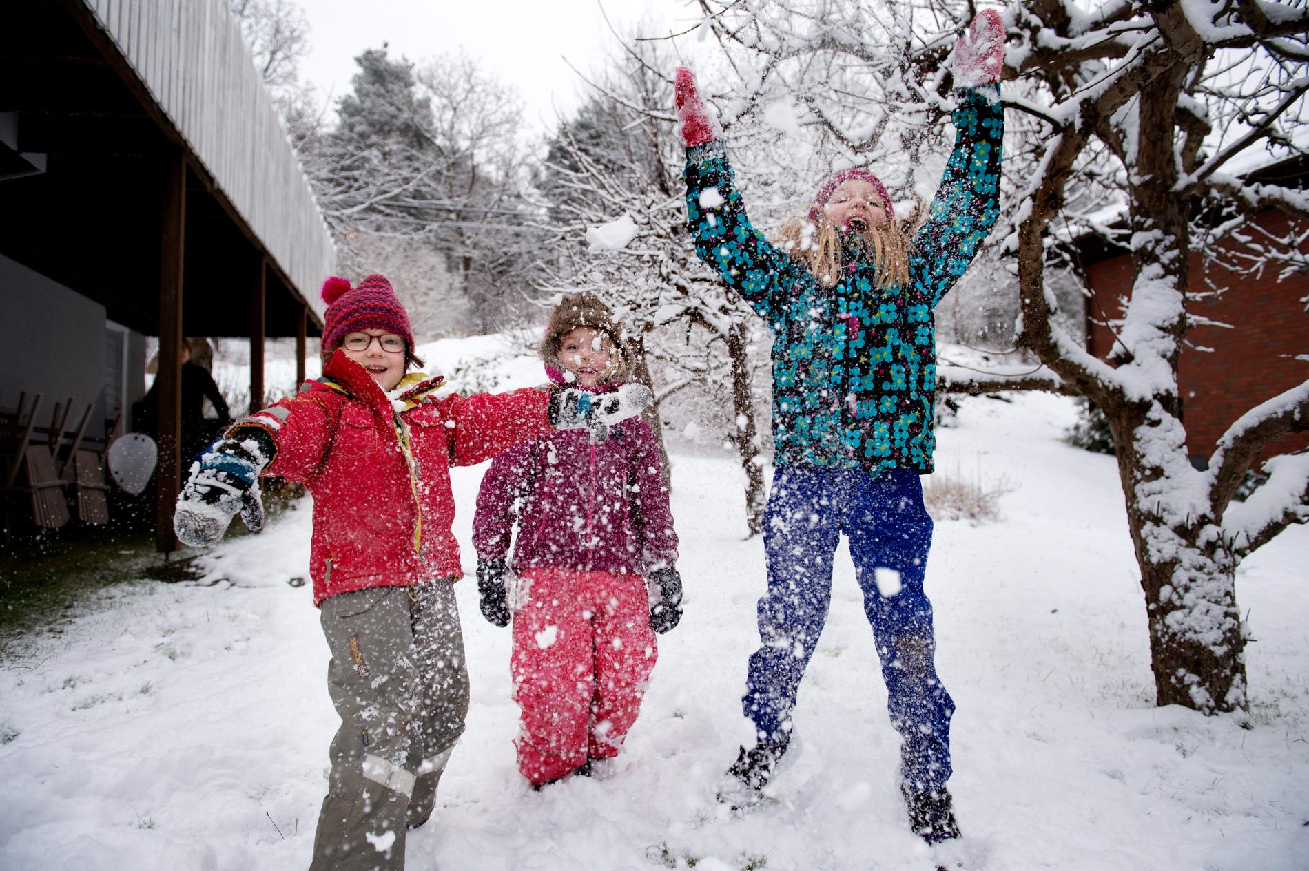 Lekande barn i snön. Arkivbild.