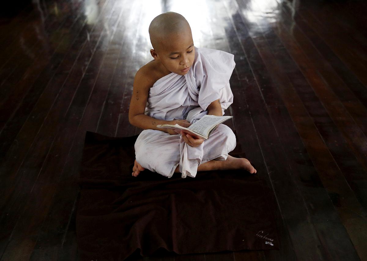 Mandalay, Myanmar: Aspirerande munken Zarnayar, 11, studerar buddistiska texter i klostret där han bor.