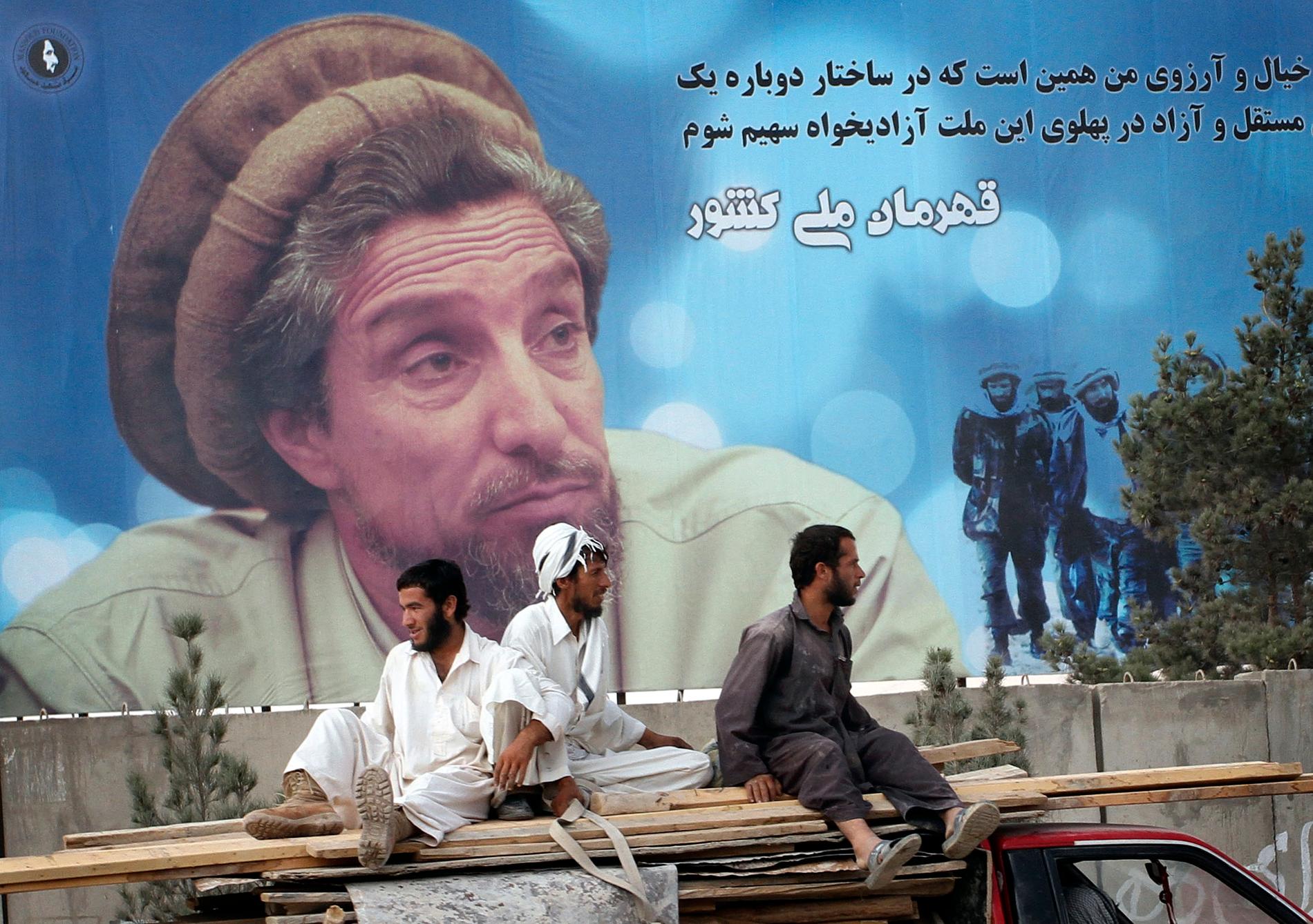 Afghaner åker förbi ett jätteporträtt av den avlidne krigsherren Ahmad Shah Massoud i huvudstaden Kabul. Arkivbild.