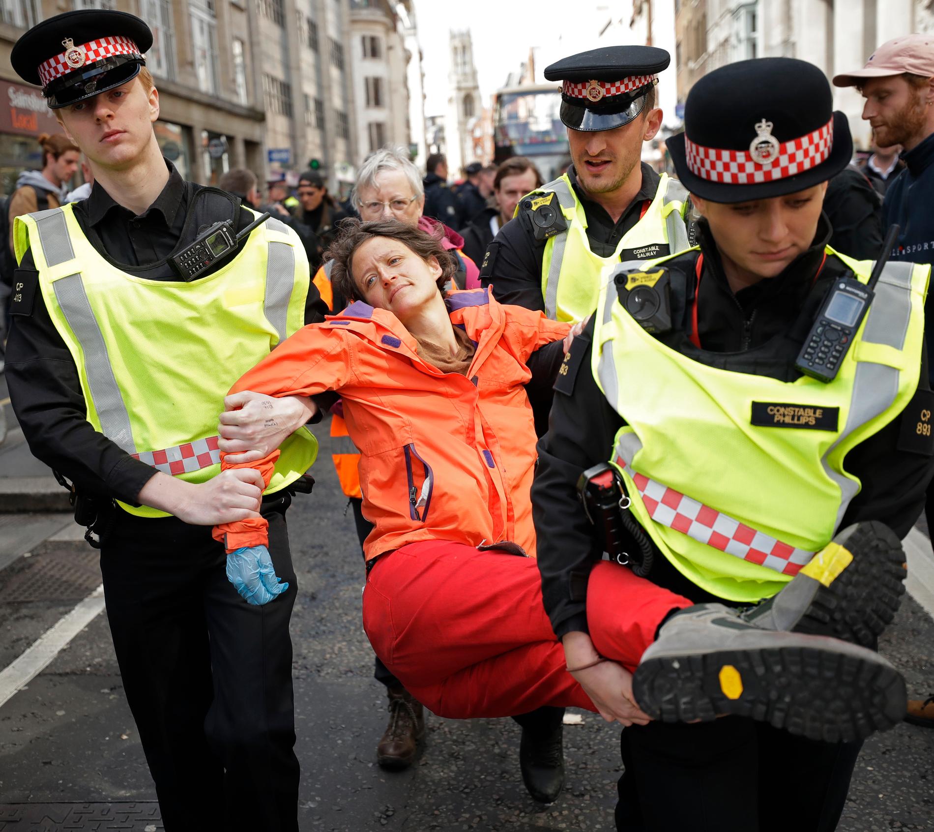 En demonstrant bärs bort sedan hon blockerat trafiken utanför Goldman Sachs i London den 25 april i år.