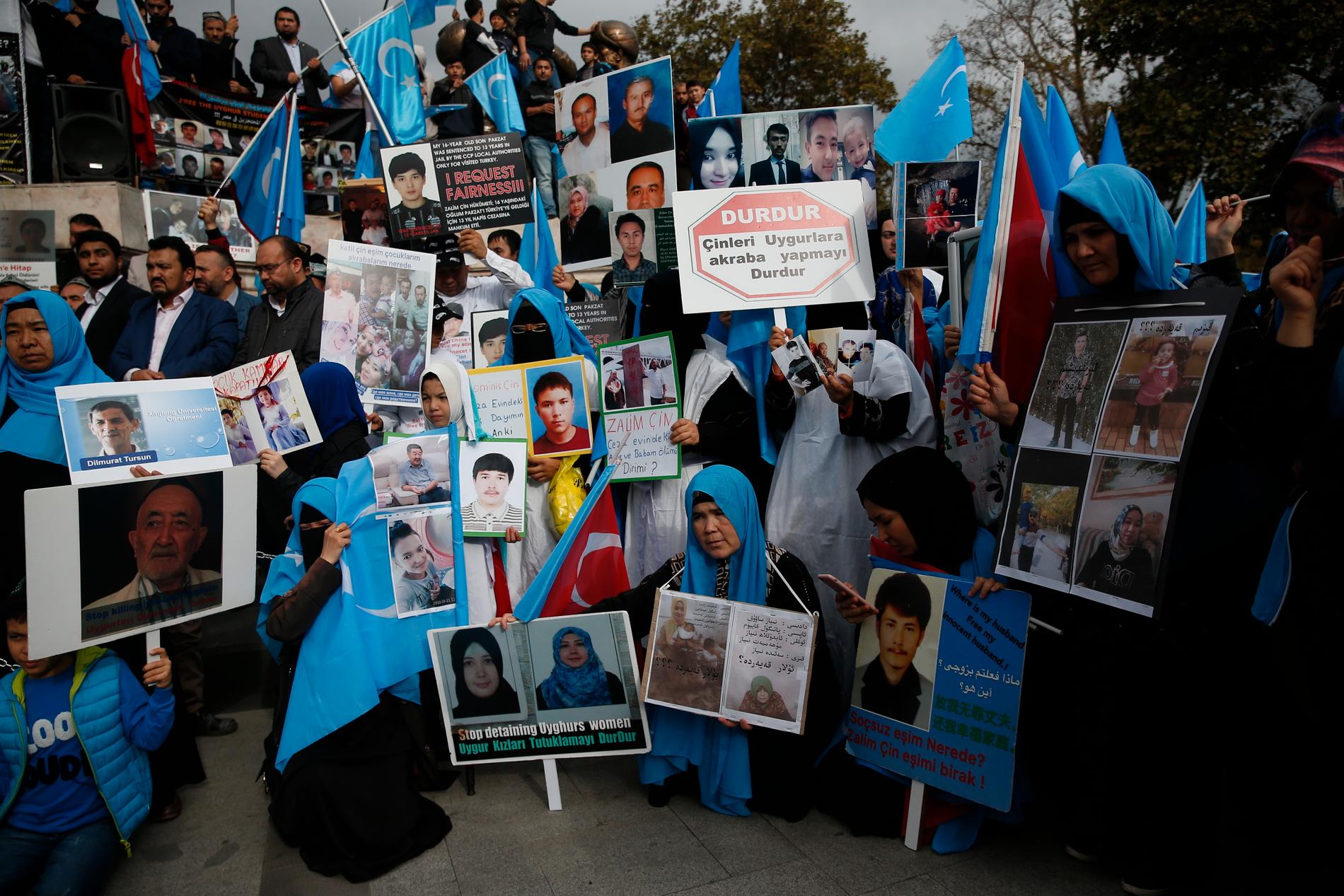 Uigurer i Turkiet håller upp bilder på försvunna nära och kära under en protest i Istanbul i november 2018. Arkivbild.