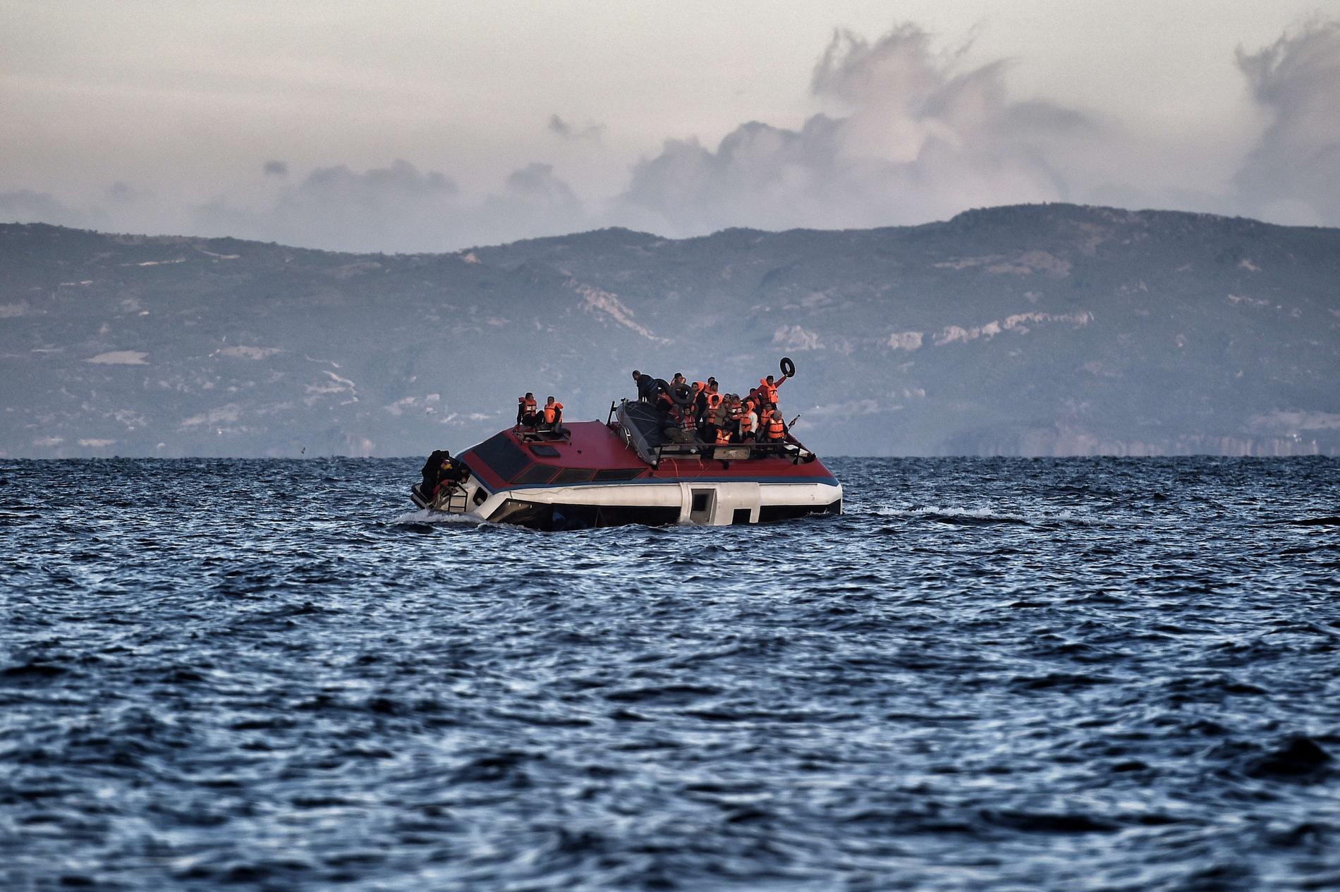 Båten som flyktingarna färdas på är på väg att sjunka mellan Turkiet och Grekland.