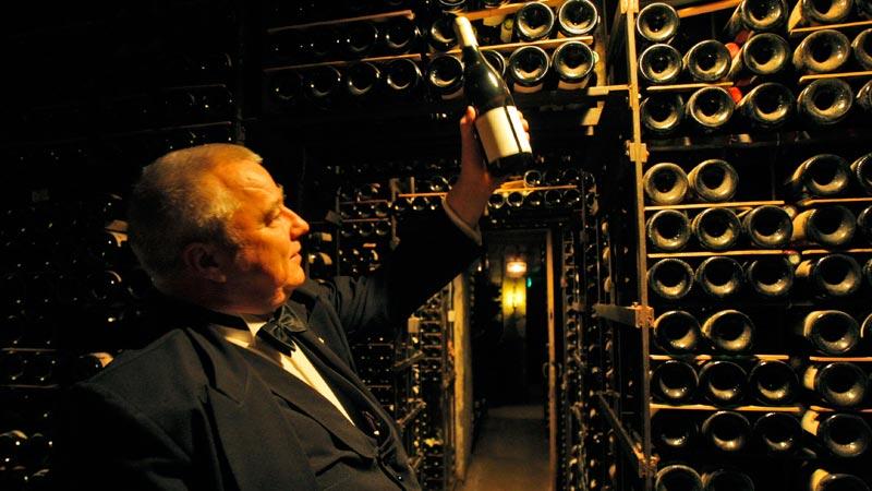 Britten David Ridgway, chefs-sommelier på La Tour d'Argent i Paris, rör sig hemtamt bland de 450 000 flaskorna i den 27 rum stora vinkällaren.