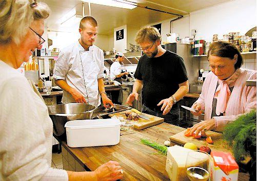 Kocken Niklas Krafft på matlagningskursen visar hur man klyver hummern.