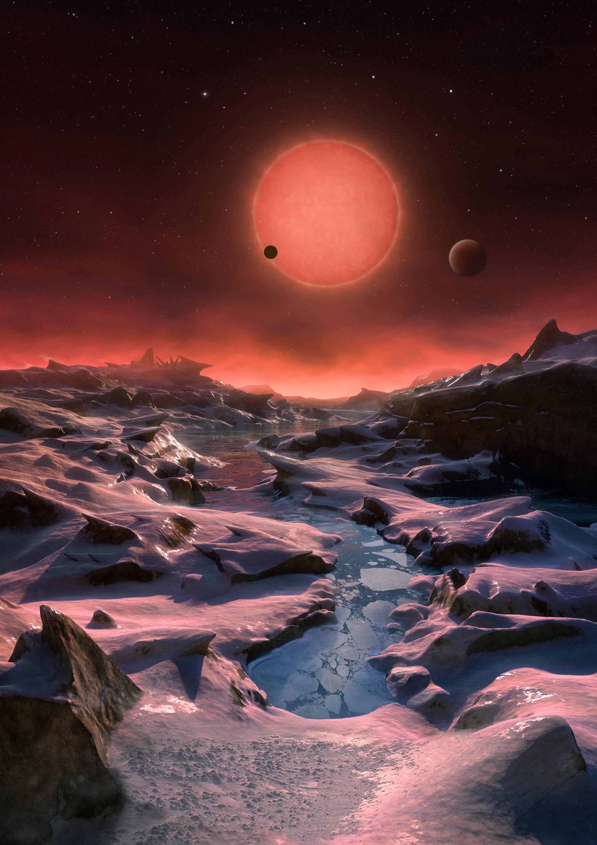 Så här skulle ytan på en av de tre exoplaneterna som ingår i Trappist-systemet kunna se ut. De sju planeterna, varav tre finns inom den "beboliga zonen", som ingår i detta system cirklar runt en kall dvärgstjärna och deras storlek påminner om jordens. Flera av planeterna ligger så nära varandra att forskarna tror att ett eventuellt liv skulle kunna färdas från en planet till en annan. Planeterna upptäcktes 2016 av belgaren Michaël Gillon.
