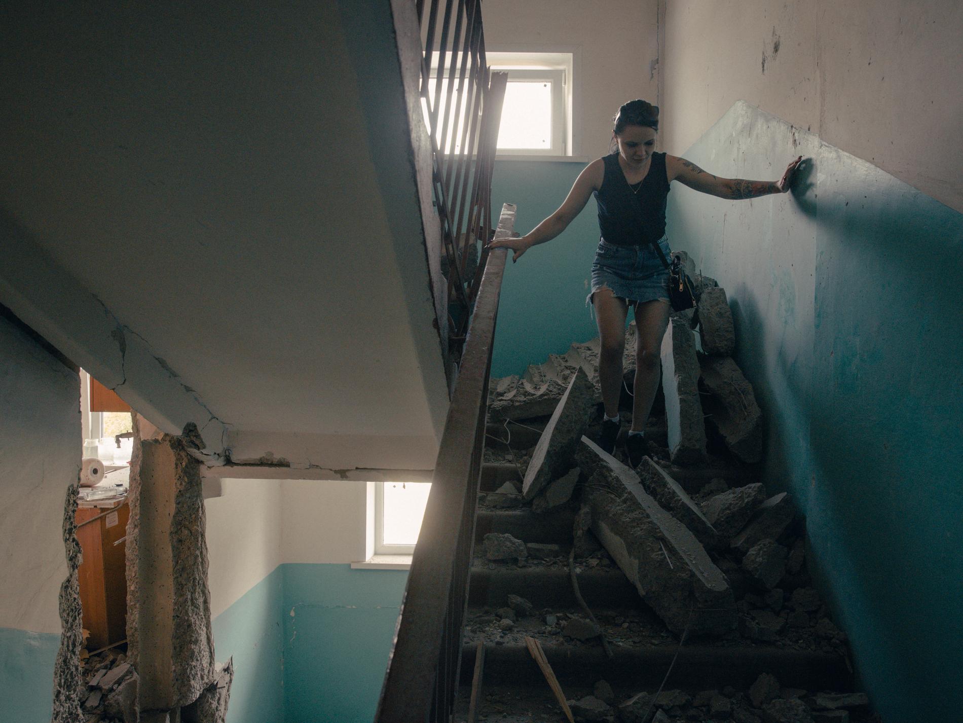 Alena Moleva undersöker skadorna efter i sitt hem efter en artilleriattack i ryska gränsstaden Sjebekino.