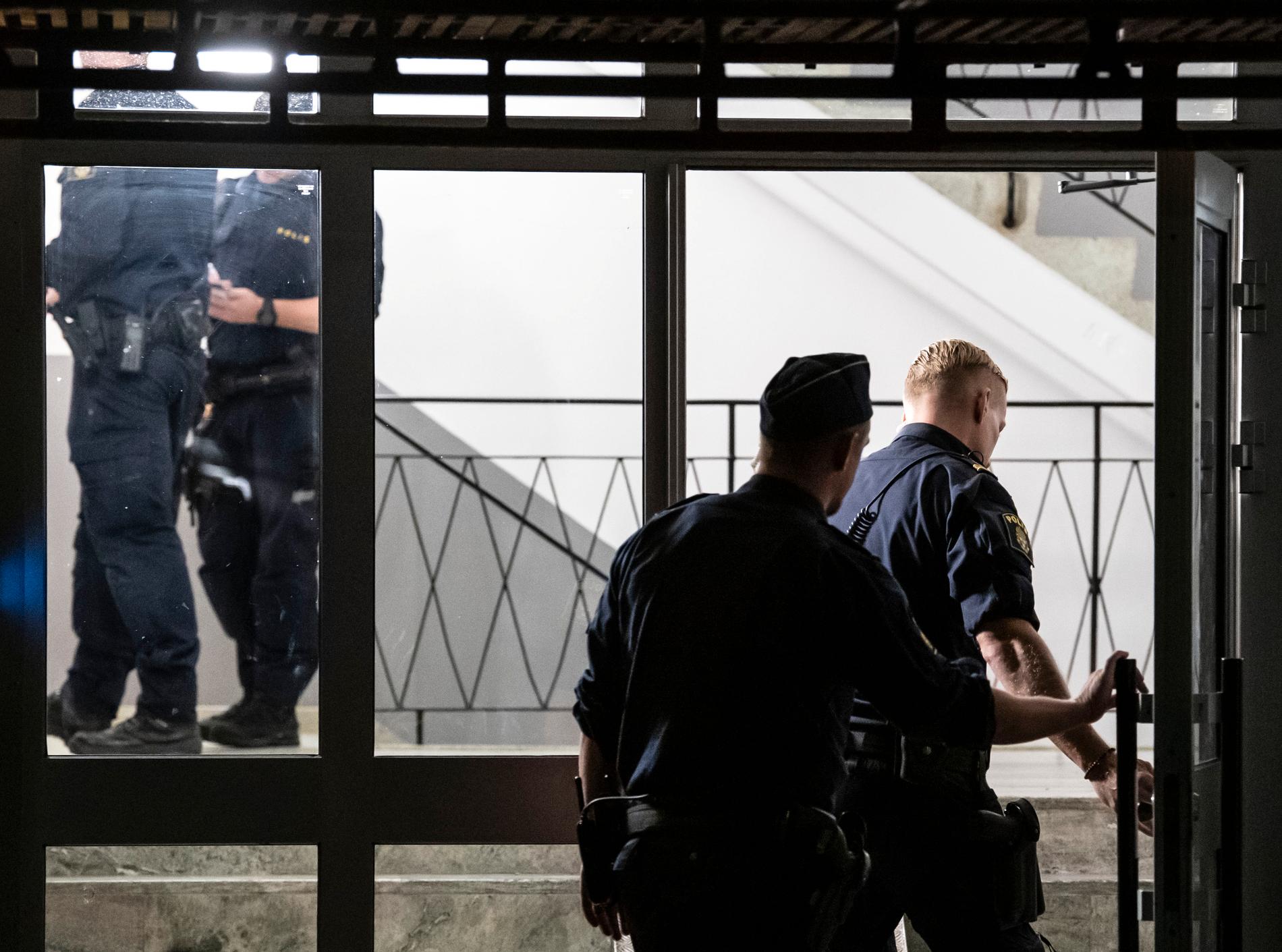 Polis på plats i ett trapphus efter skottlossningen
